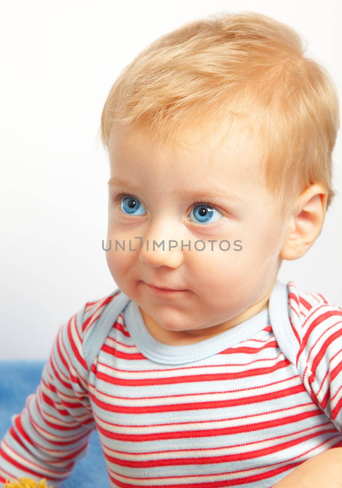 Studio portrait of a happy one year old baby boy.