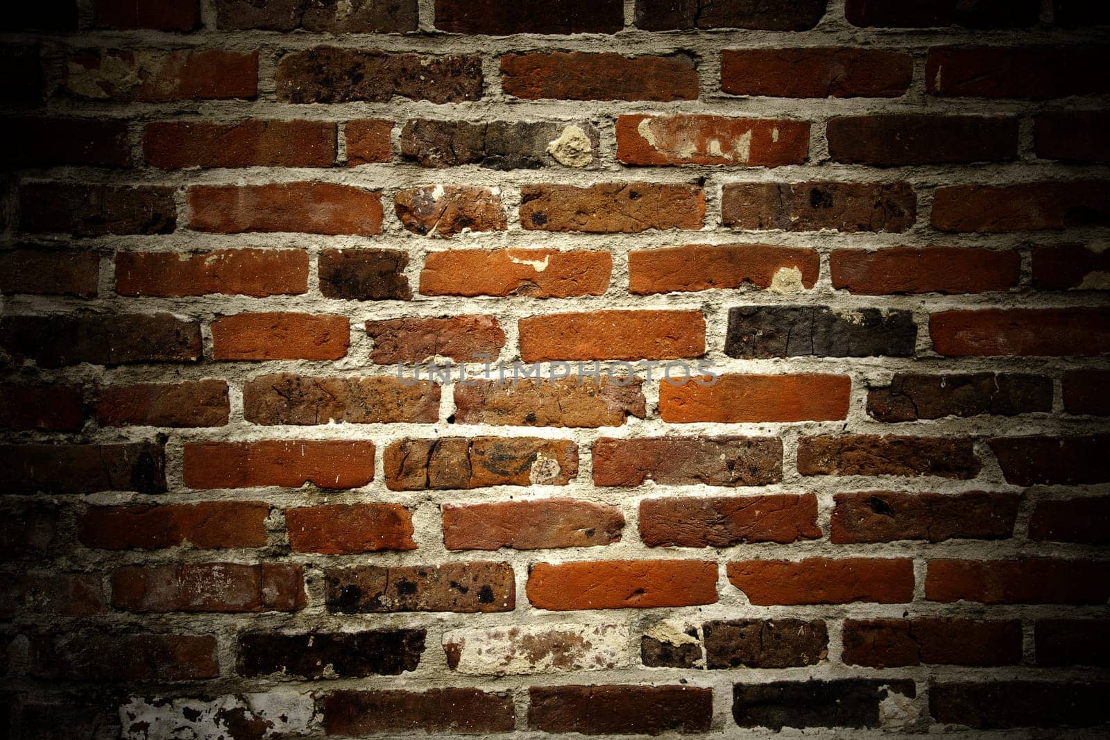 Brick texture with copyspace and spotlight.