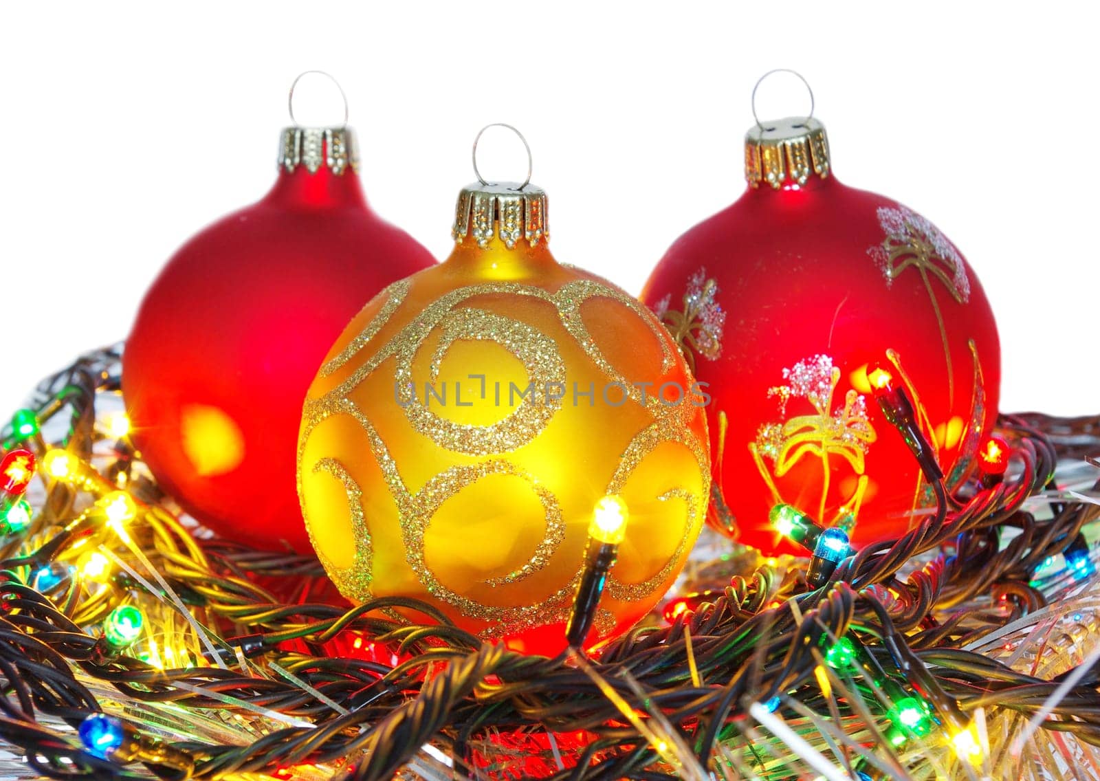 Christmas tinsel and toys on a white background