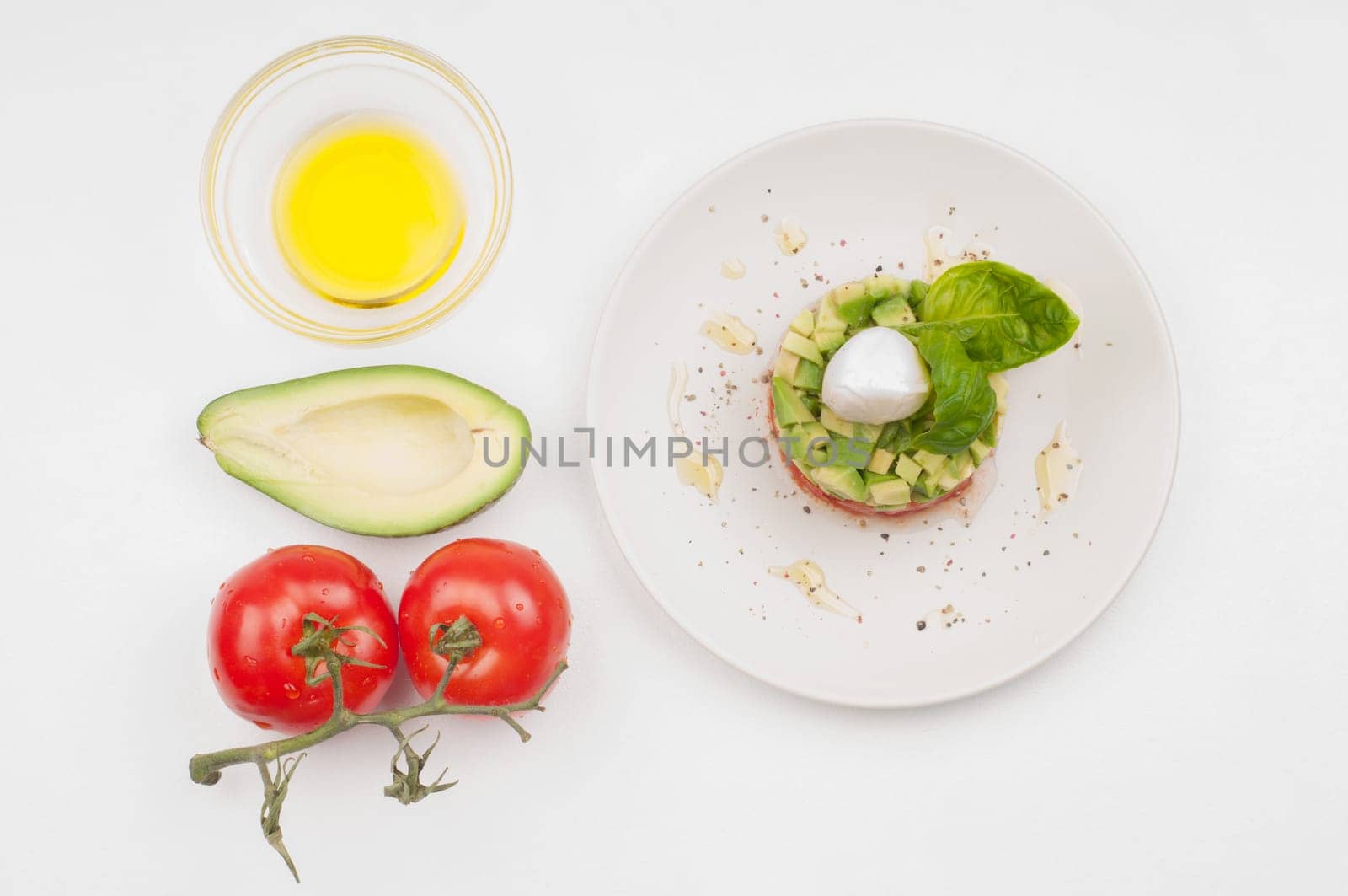 Tomatoes, avocado and olive oil - salad ingridients and salad