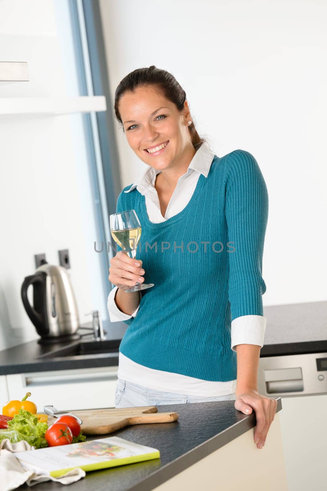 Smiling woman kitchen drinking wine preparing vegetables housewife