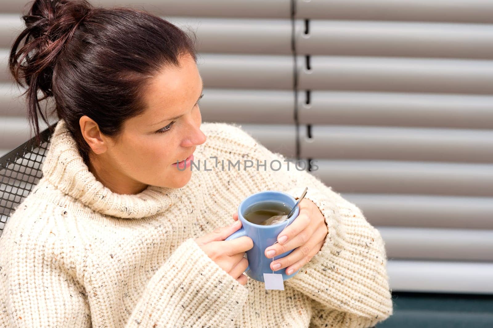 Woman drinking cup tea knitted sweater yard relaxing fall