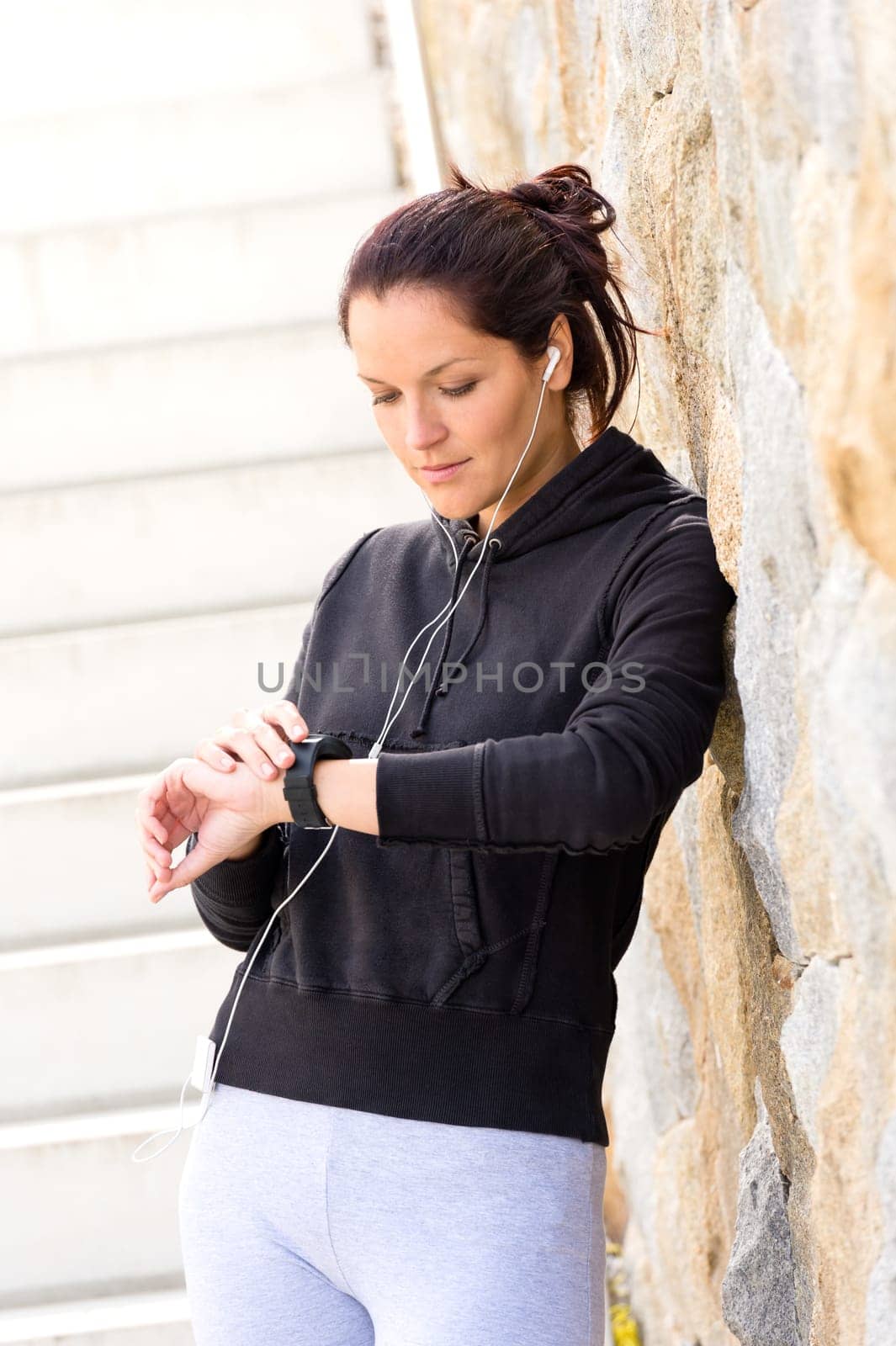 Young woman checking after exercising running sport mp3 sweatsuit