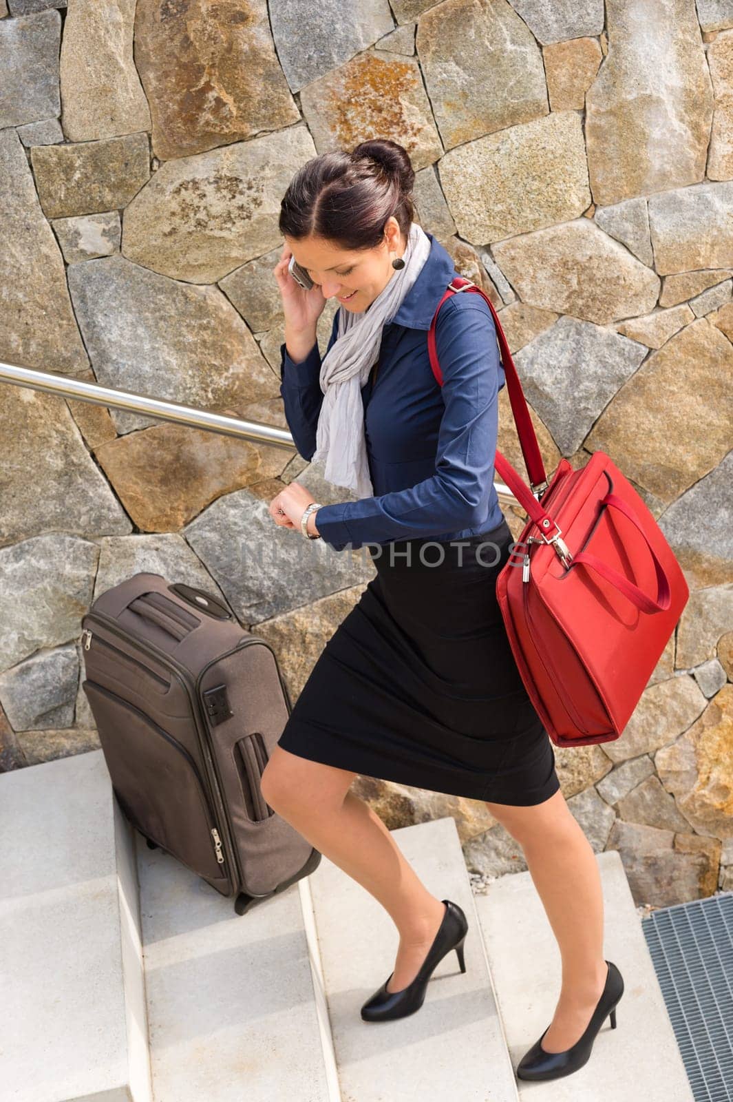 Traveling businesswoman hurried rushing climbing baggage carry-on shoulder bag