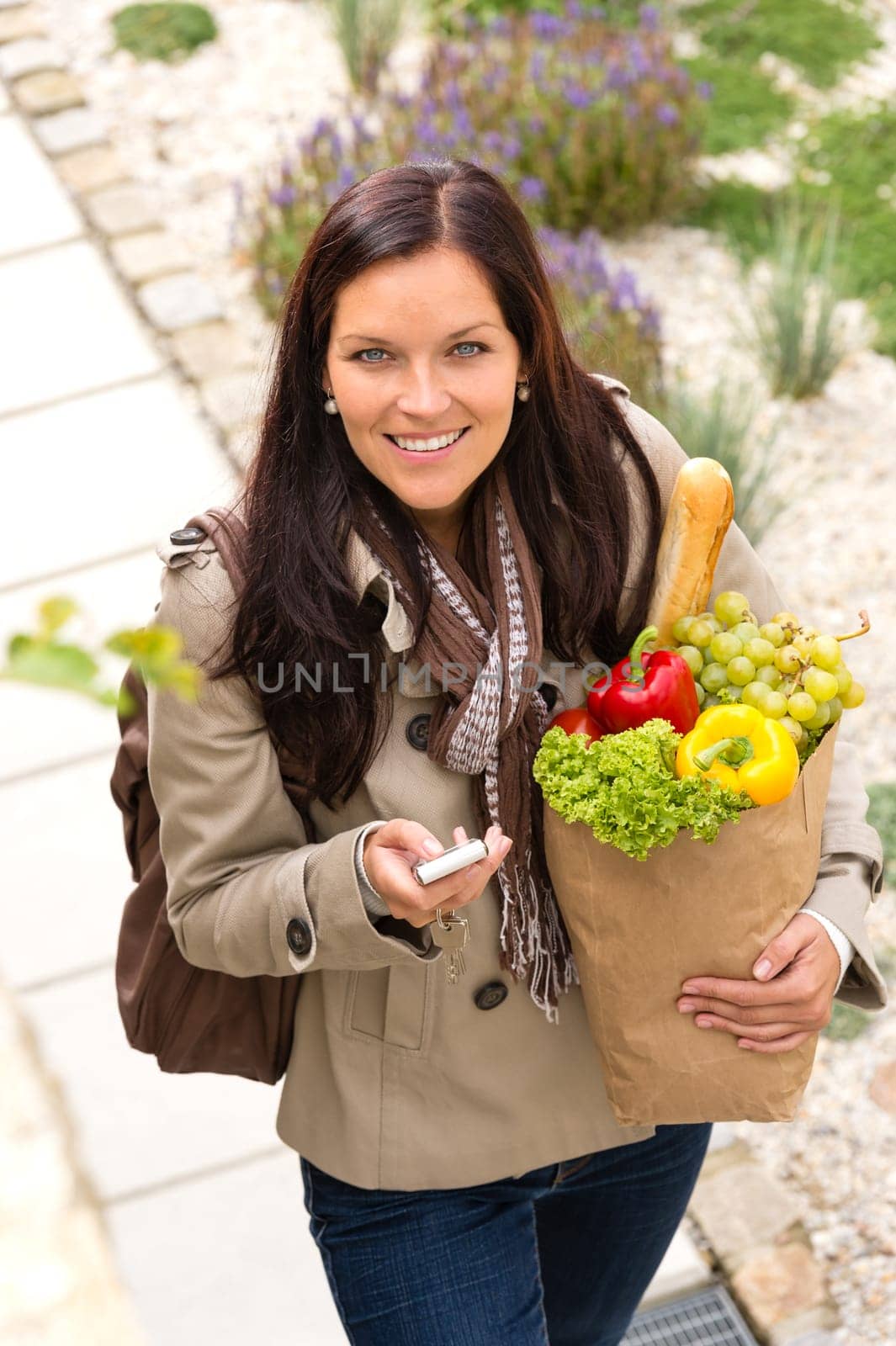 Happy woman shopping phone groceries texting vegetables mobile bag