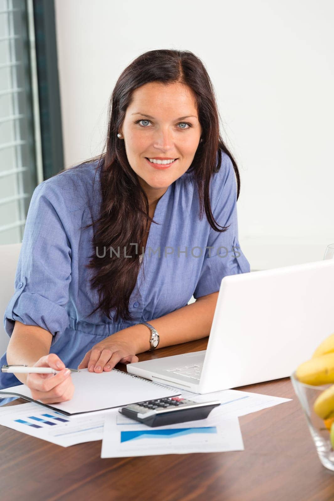 Happy businesswoman working office writing calculating finance analyzing