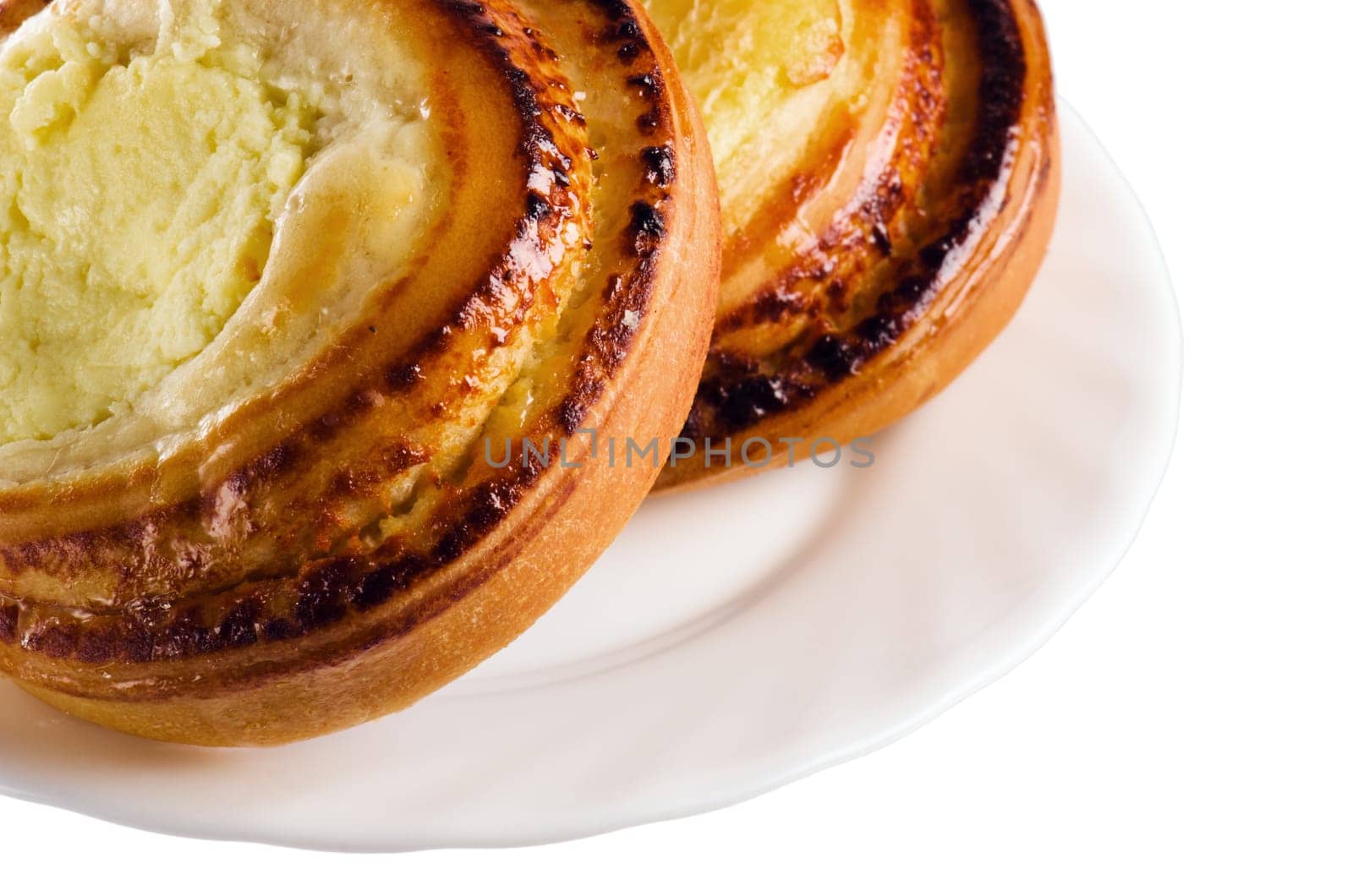 Fresh bread rolls with cheese on a saucer is isolated on white