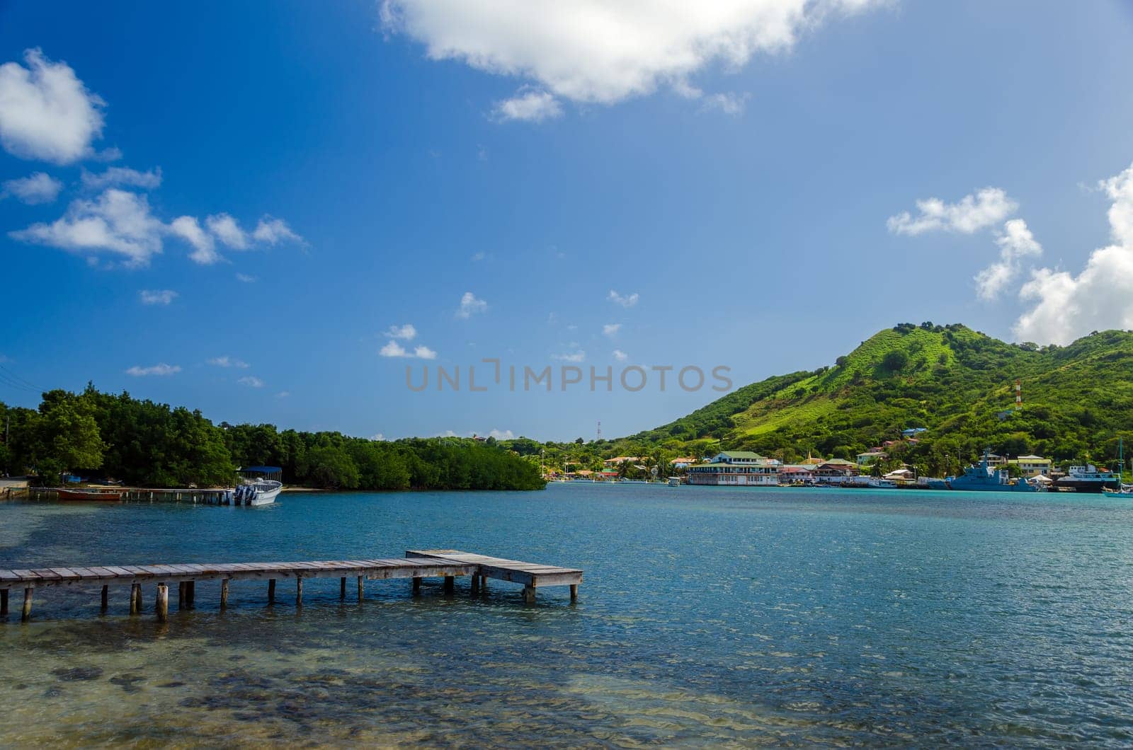 Wooden dock with tropical island in background in San Andres y Providencia, Colombia