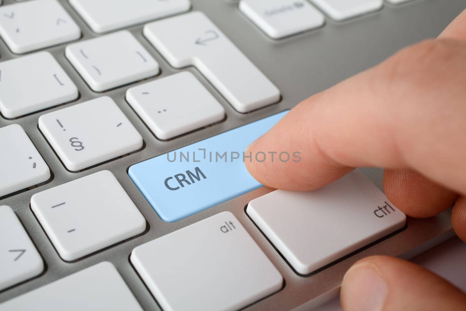 CRM (customer relationship management) concept. Man press CRM key on computer keyboard.
