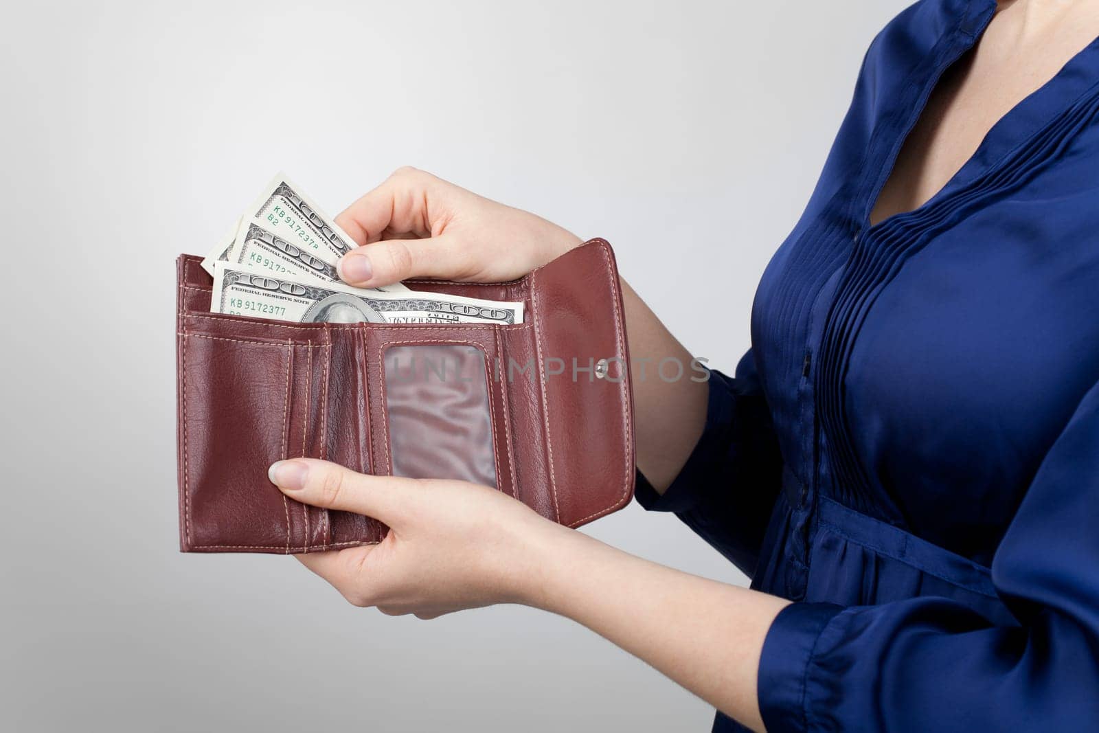 Woman take dollar money out from wallet.