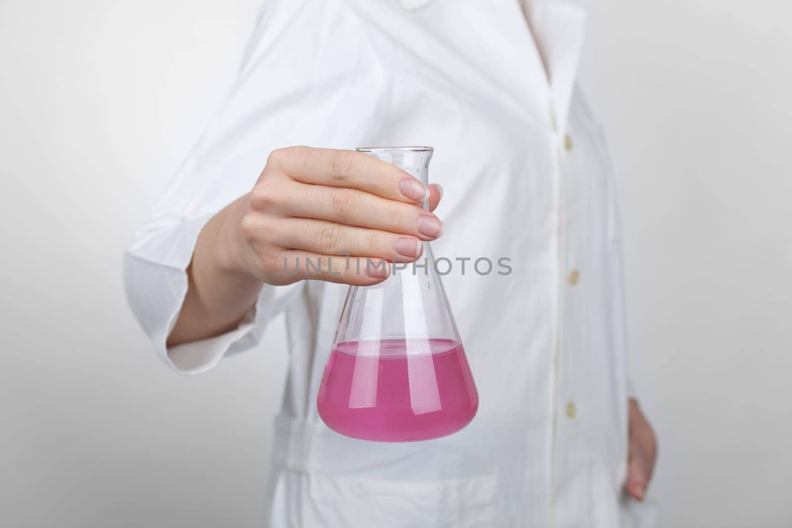 Female chemist with laboratory glass.