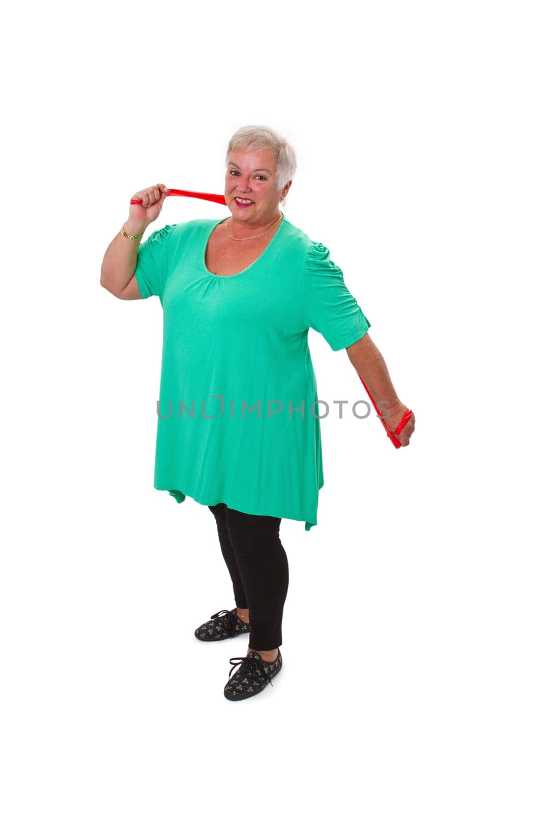 Senior woman with stretch band doing sports - isolated on white background