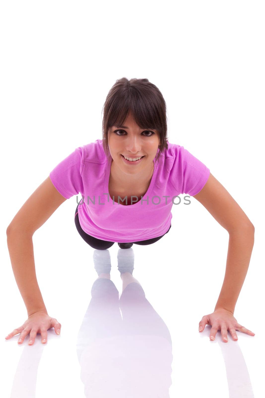 Young beautiful caucasian fitness woman doing push up exercises on floor,isolated on white background