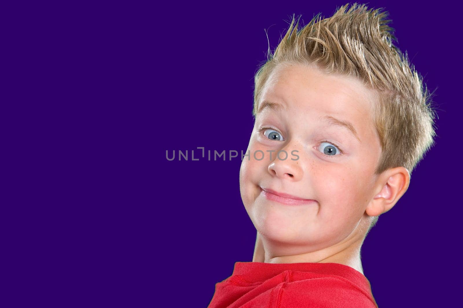 happy boy in front of blue background
