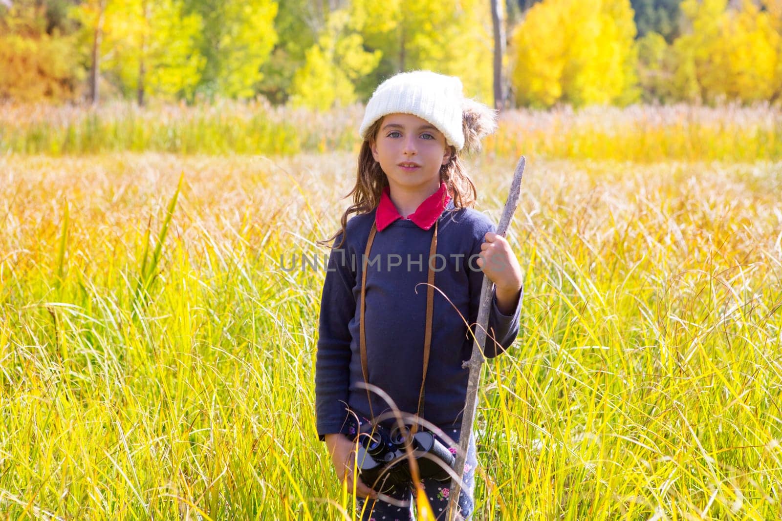 Explorer binocuar kid girl in yellow autumn nature outdoor