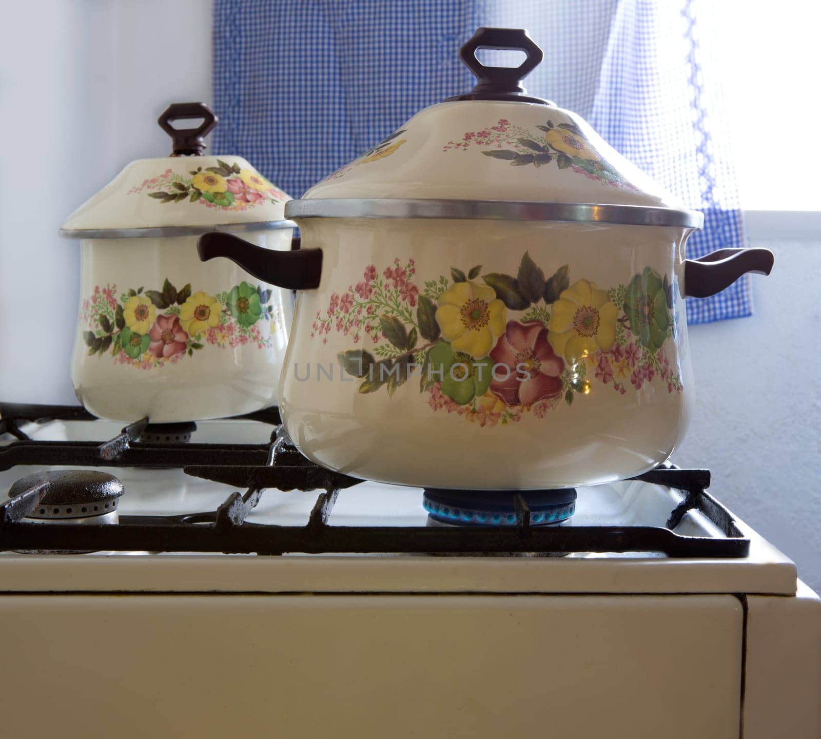 Retro vintage kitchen with pots pans with porcelain flowers