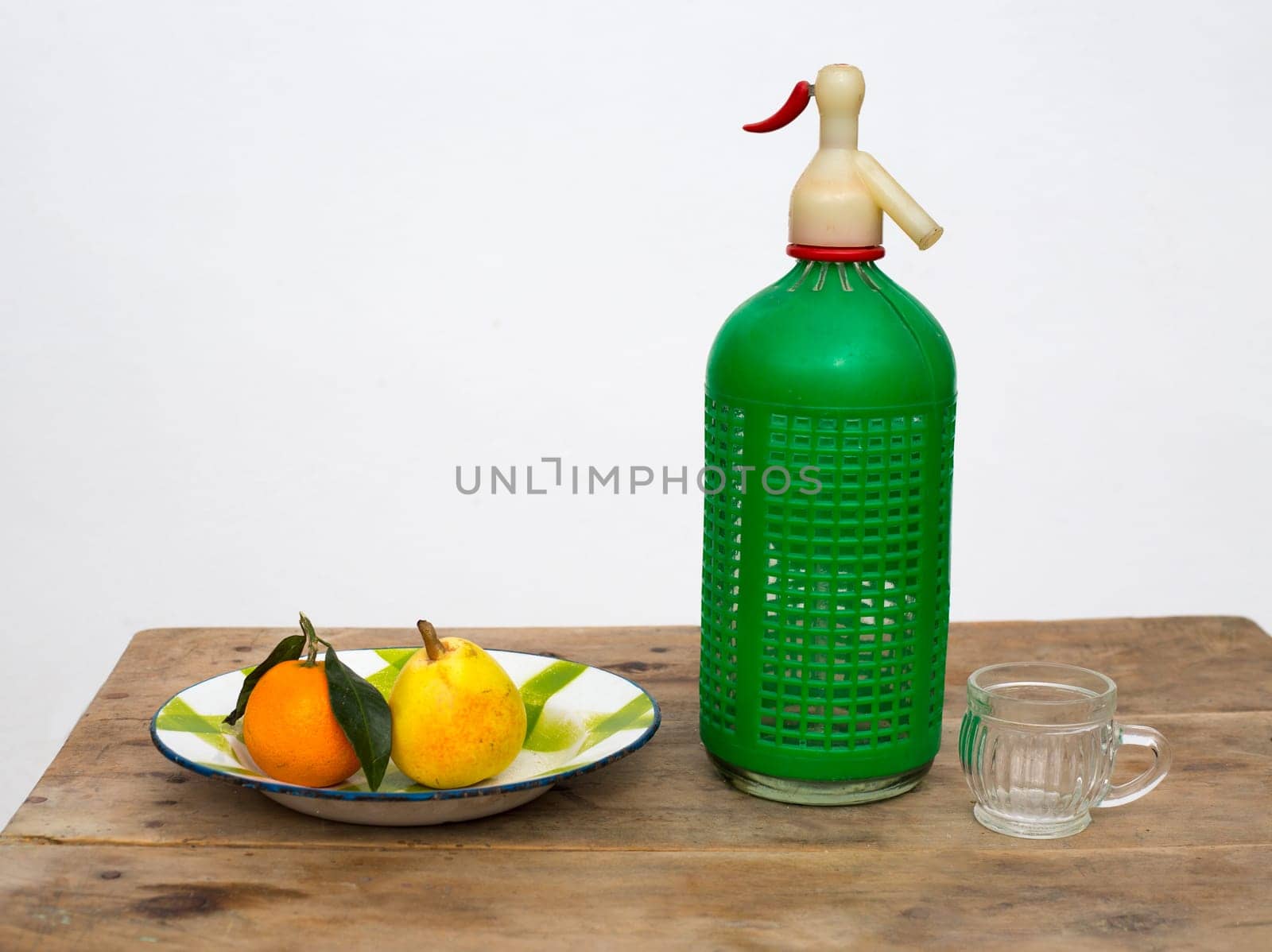 fruits tangerine and pear in vintage porcelain dish with retro soda bottle