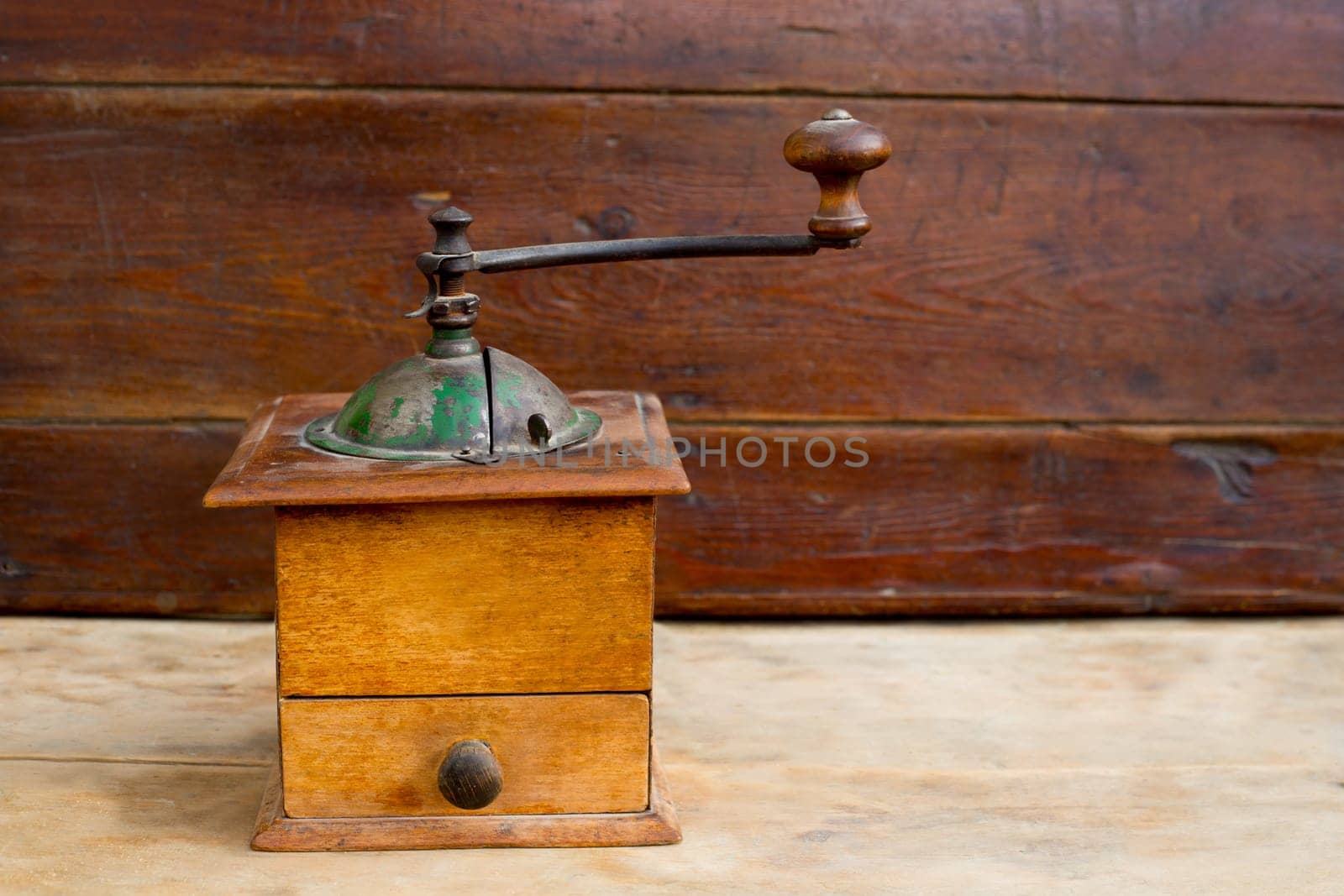 retro old coffee grinder with vintage wooden background