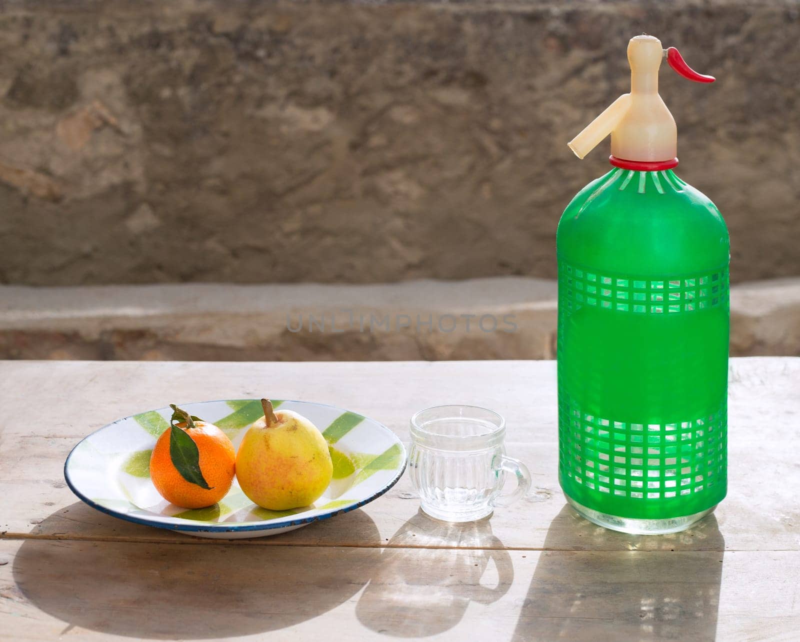 fruits tangerine and pear in vintage porcelain dish with retro soda bottle