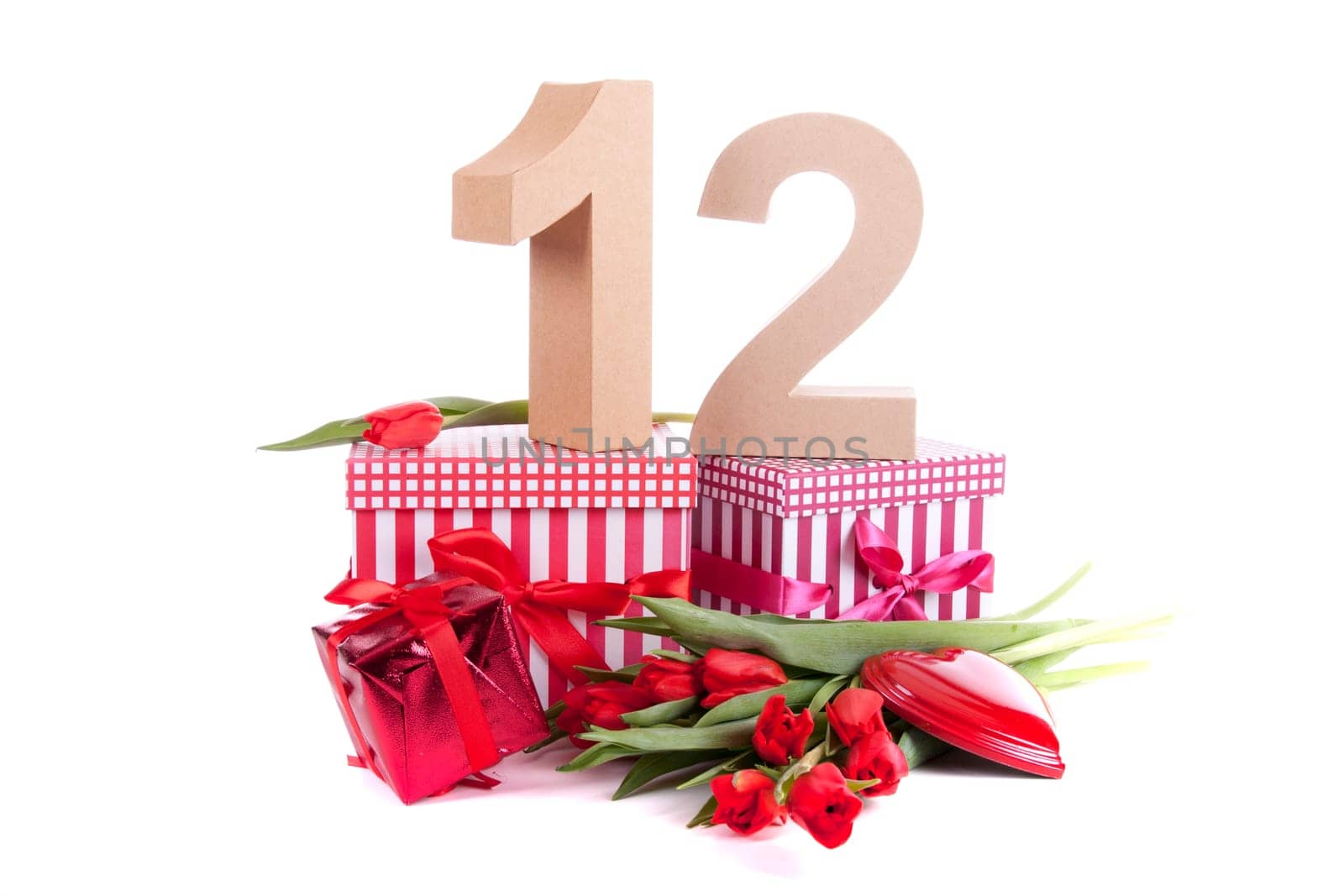 Number of age in a colorful studio setting with a red heart and gifts and tulips