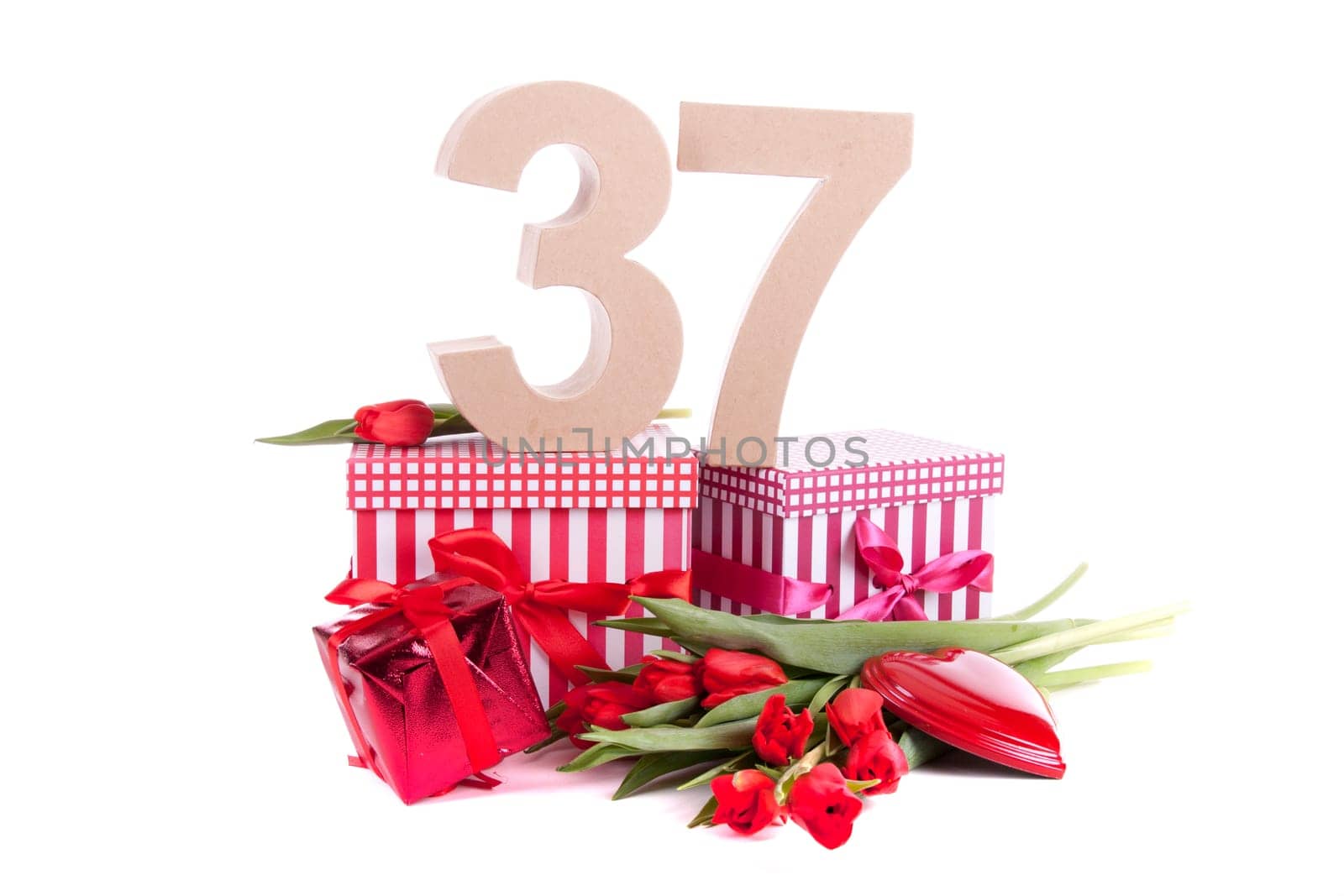 Number of age in a colorful studio setting with a red heart and gifts and tulips