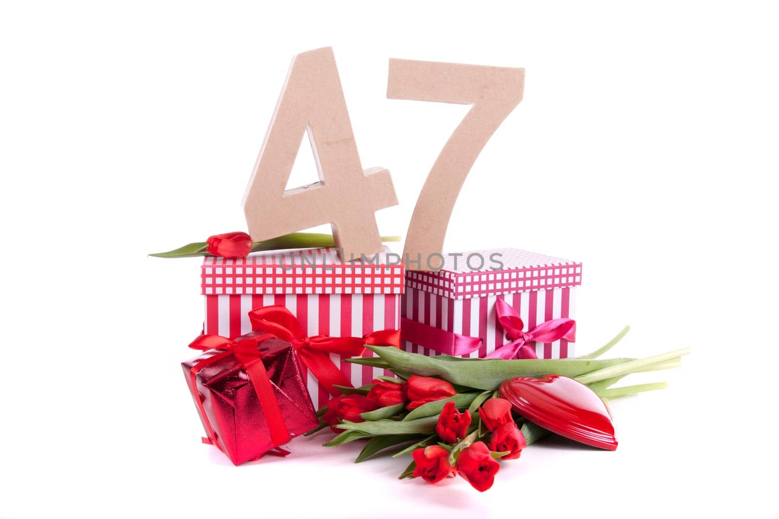 Number of age in a colorful studio setting with a red heart and gifts and tulips