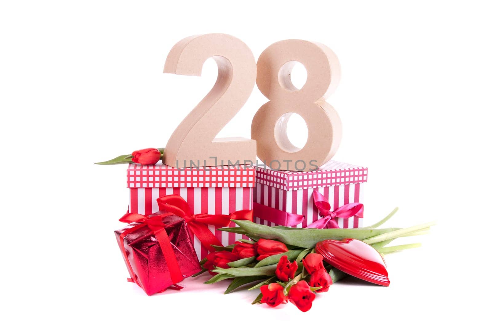Number of age in a colorful studio setting with a red heart and gifts and tulips