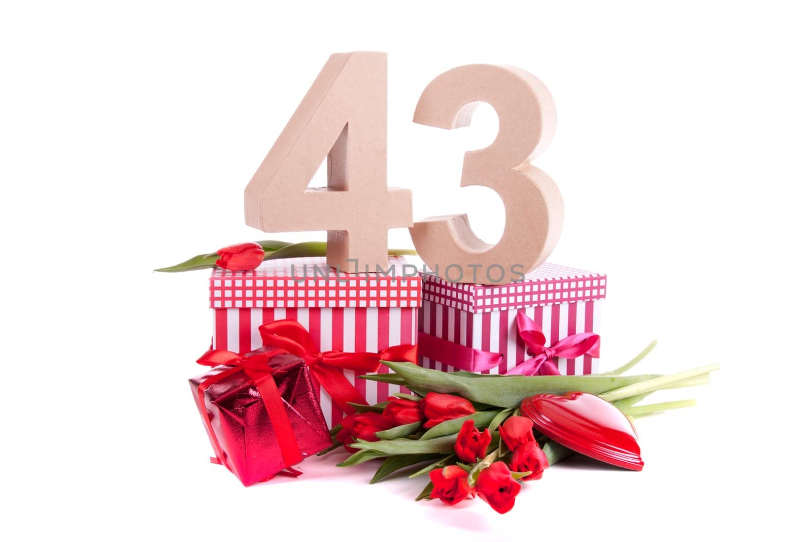 Number of age in a colorful studio setting with a red heart and gifts and tulips