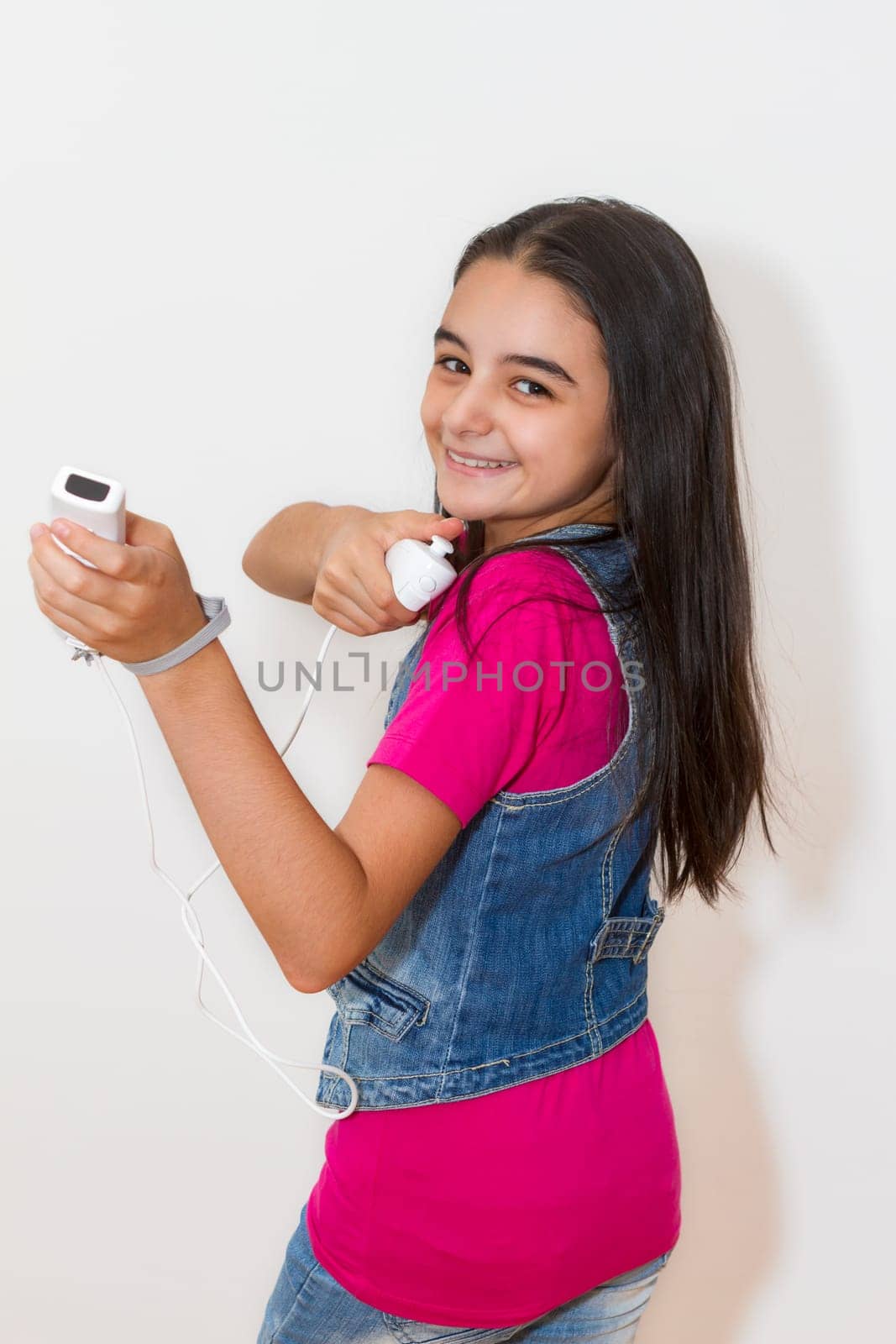 A teenage girl playing video game, isolated on white background
