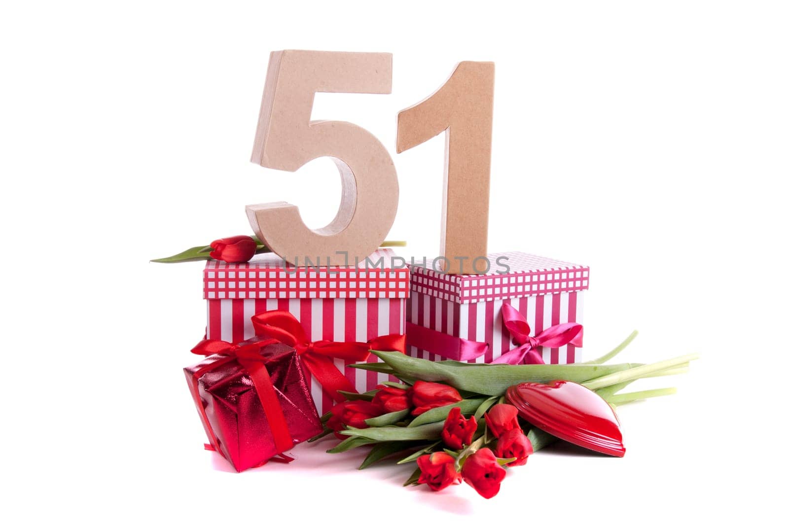 Number of age in a colorful studio setting with a red heart and gifts and tulips