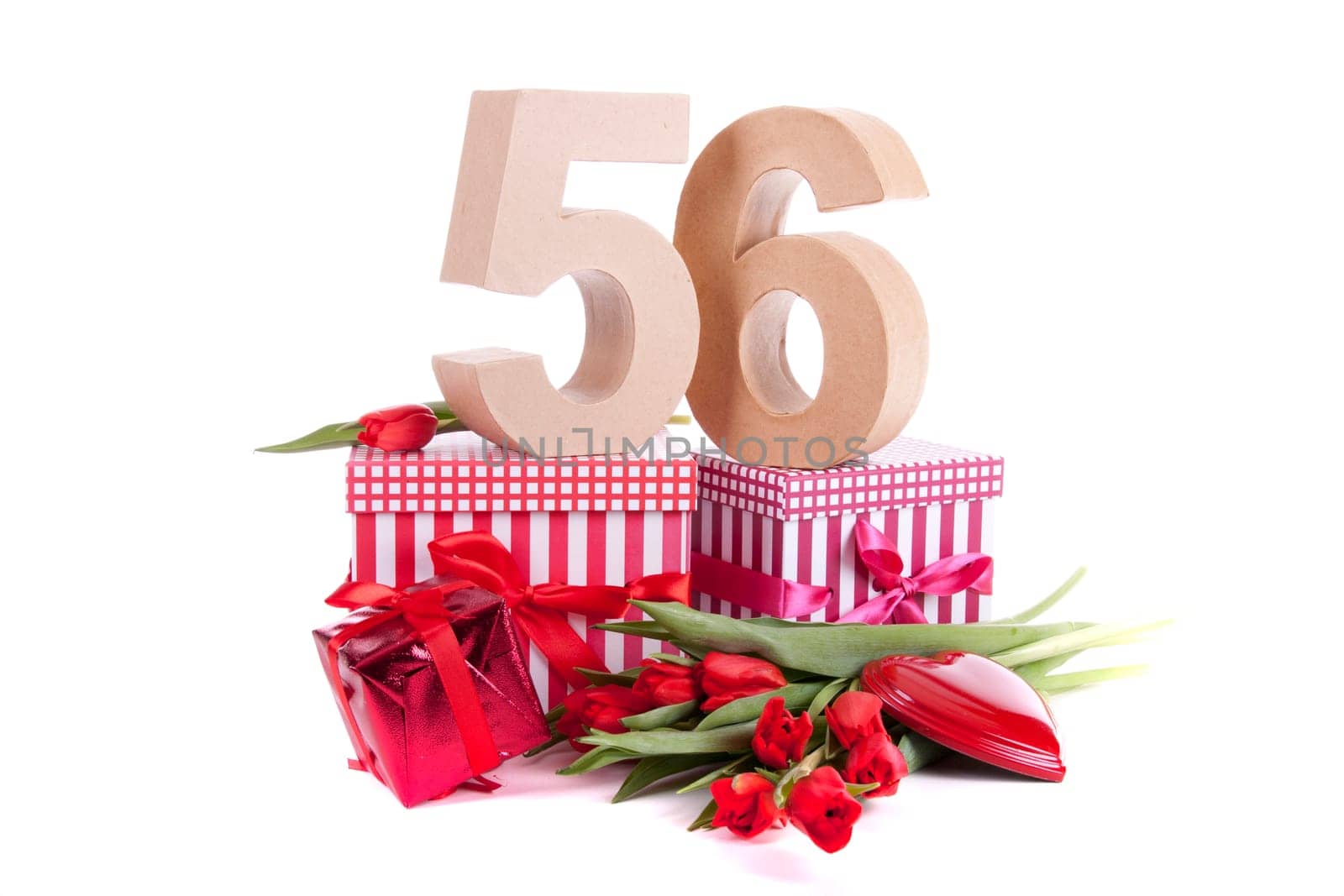 Number of age in a colorful studio setting with a red heart and gifts and tulips
