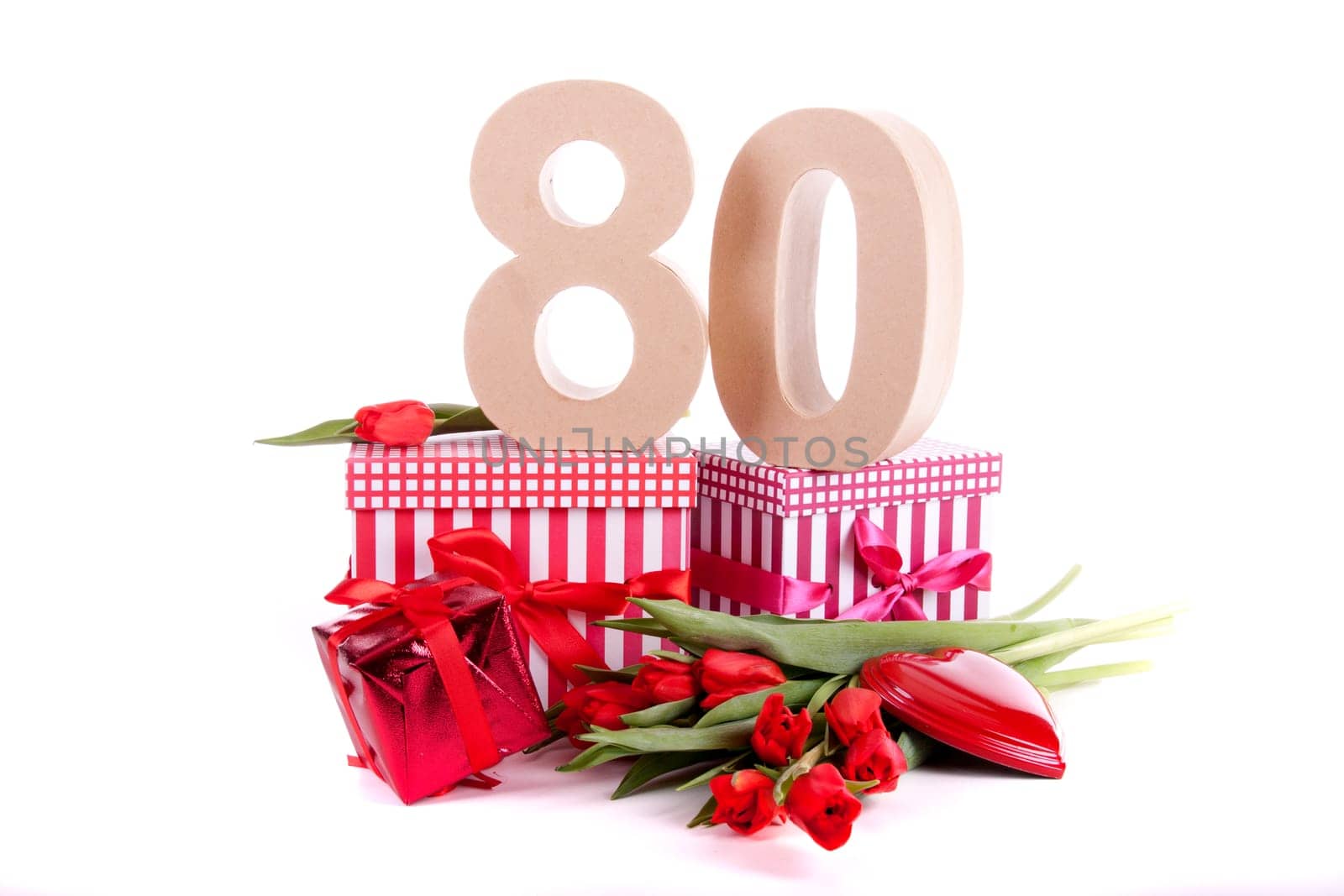 Number of age in a colorful studio setting with a red heart and gifts and tulips