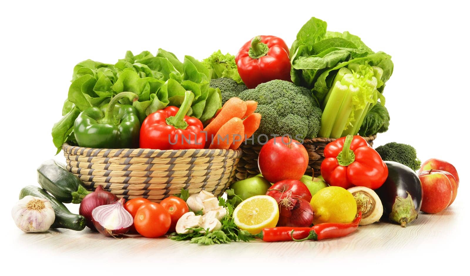 Composition with raw vegetables in wicker basket isolated on white