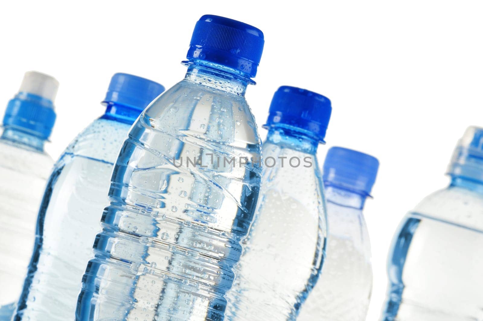 Composition with polycarbonate plastic bottles of mineral water isolated on white background