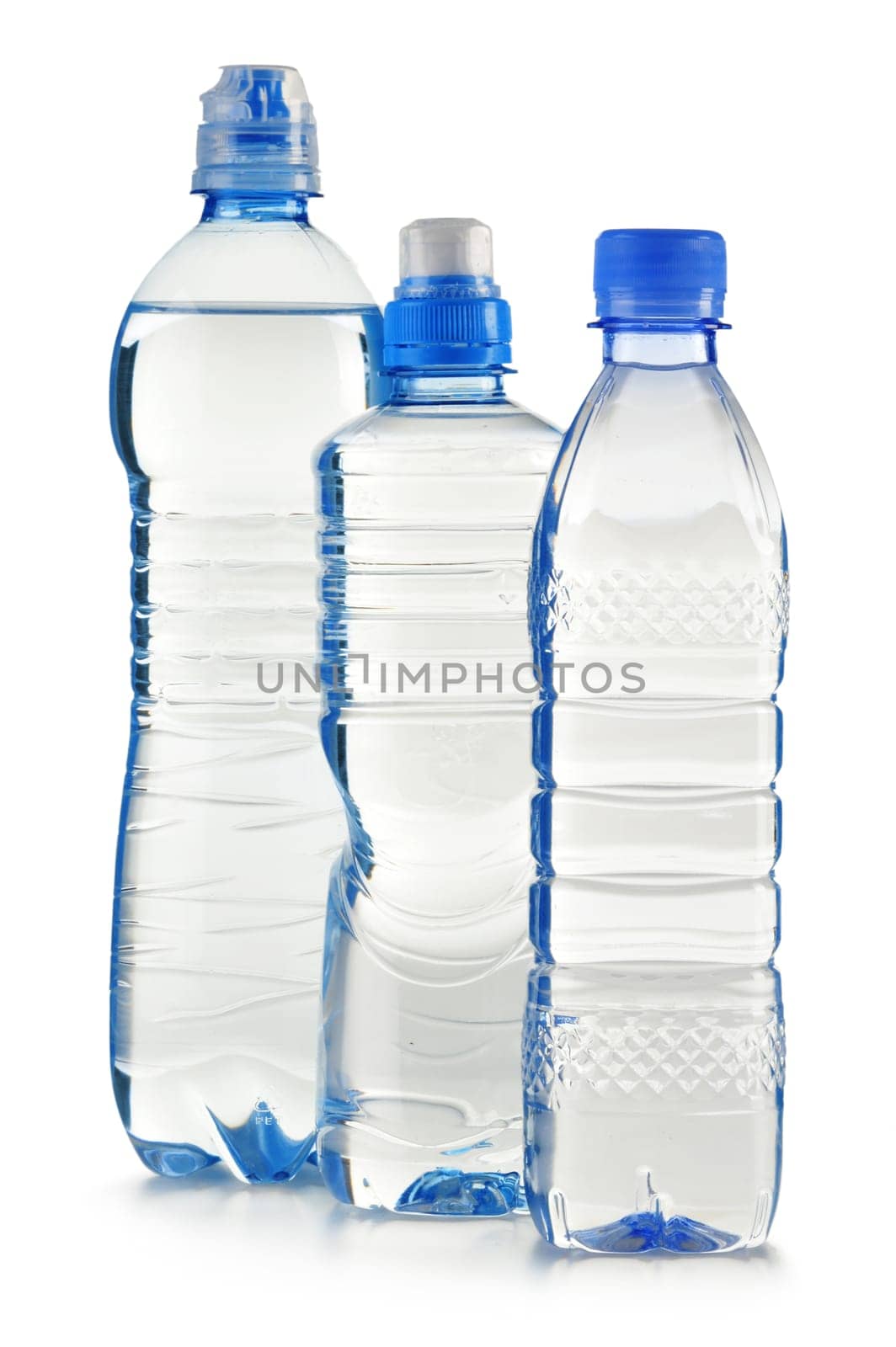 Composition with polycarbonate plastic bottles of mineral water isolated on white background