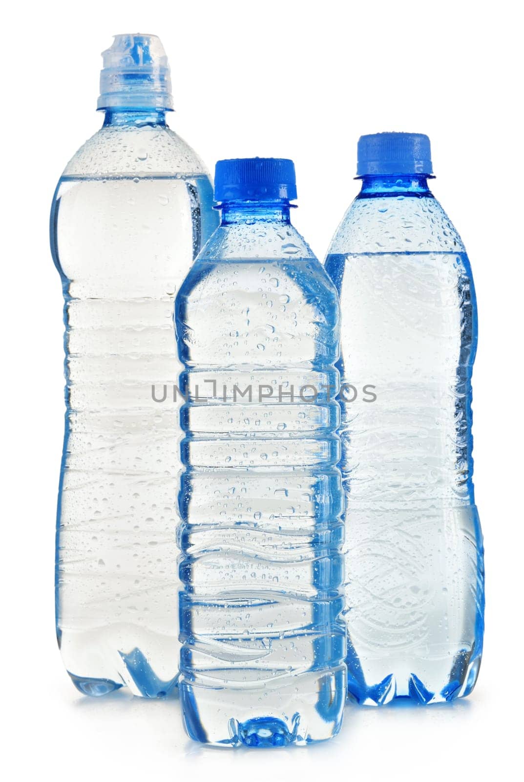 Composition with polycarbonate plastic bottles of mineral water isolated on white background