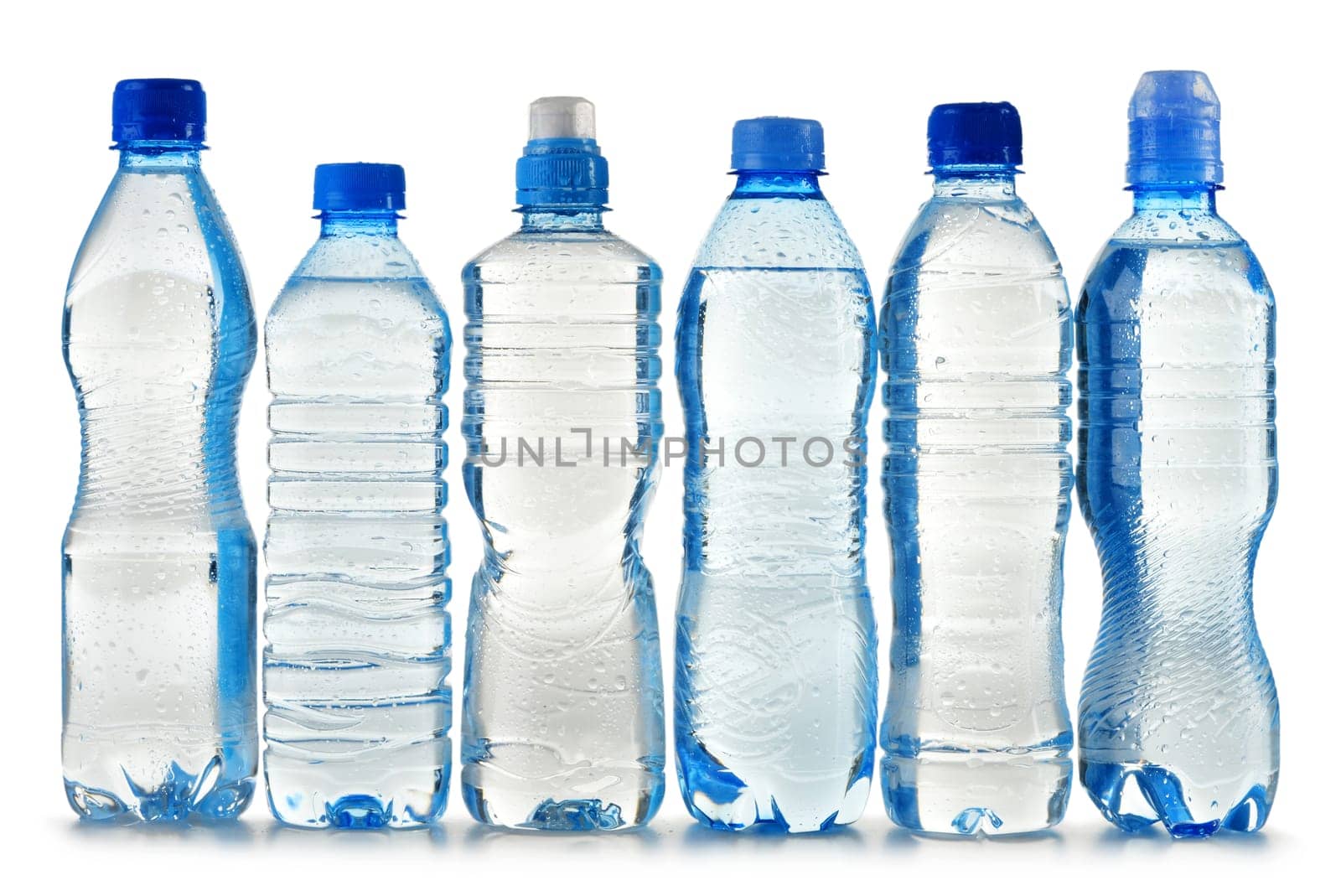 Composition with polycarbonate plastic bottles of mineral water isolated on white background