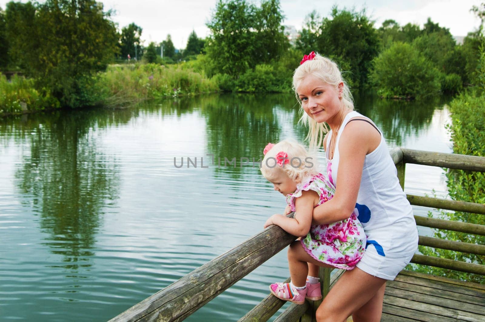 mother and small daughter by the pond at the Zoo