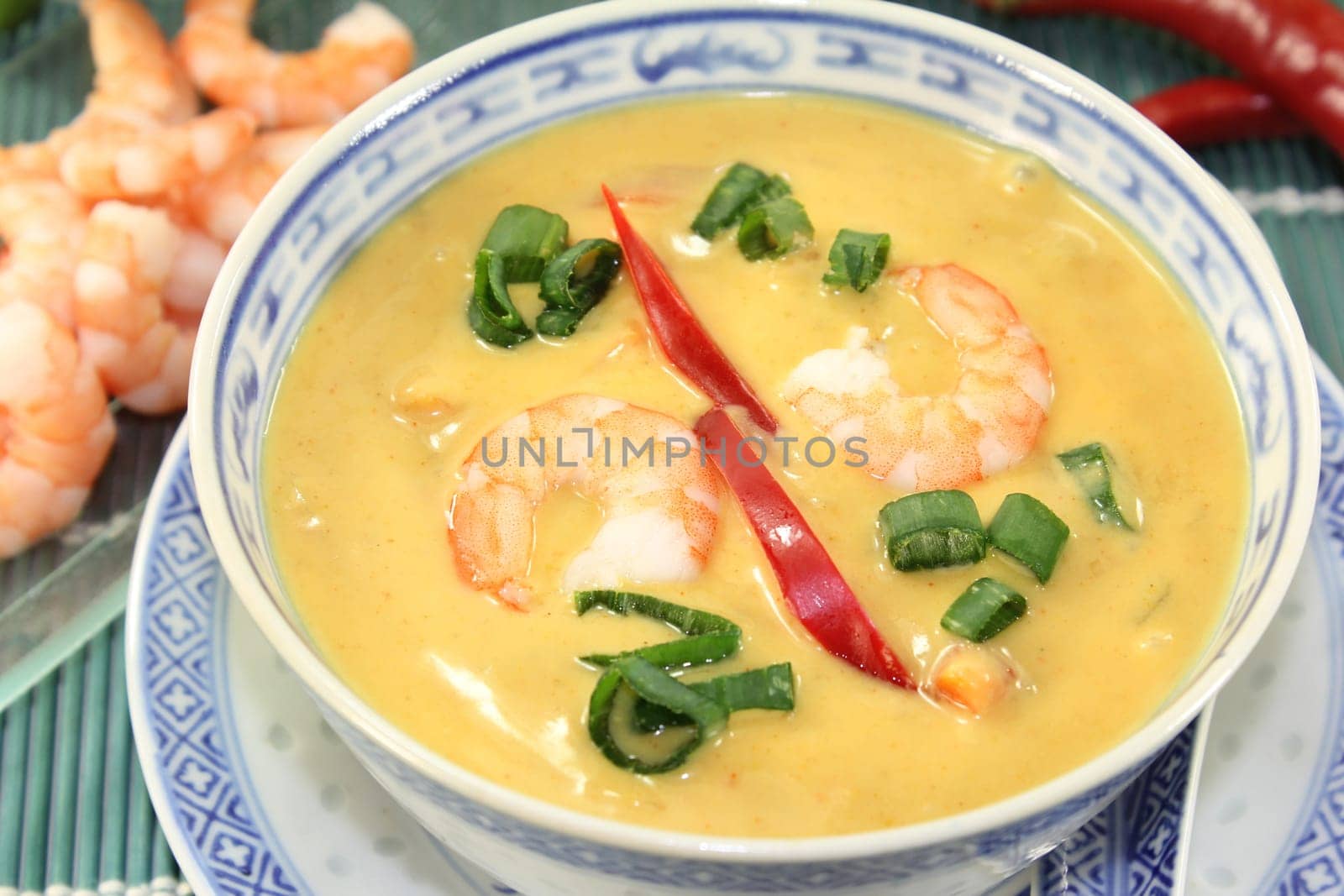 Curry soup with colourful vegetables and prawns