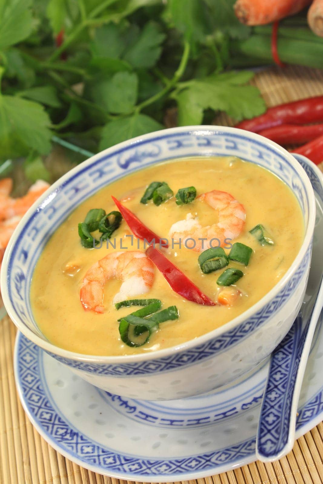 Curry soup with colourful vegetables and prawns