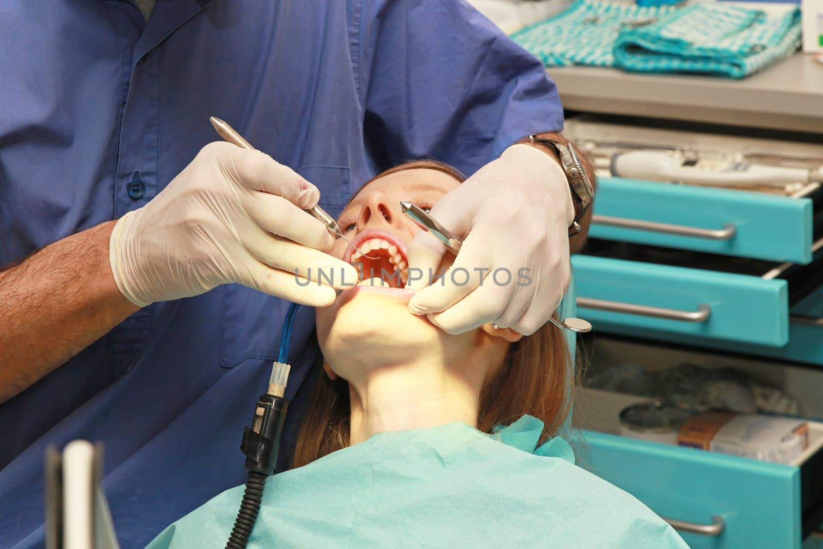Patient with open mouth in dentist office