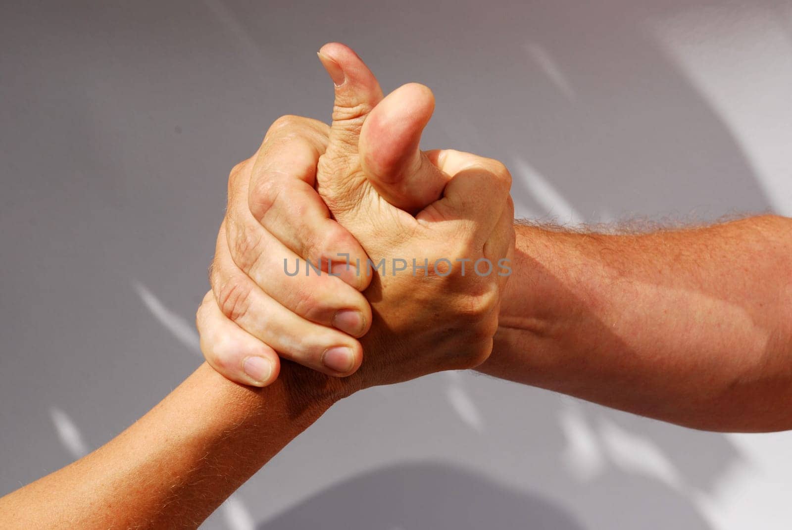 two middle aged hands competing or handshaking