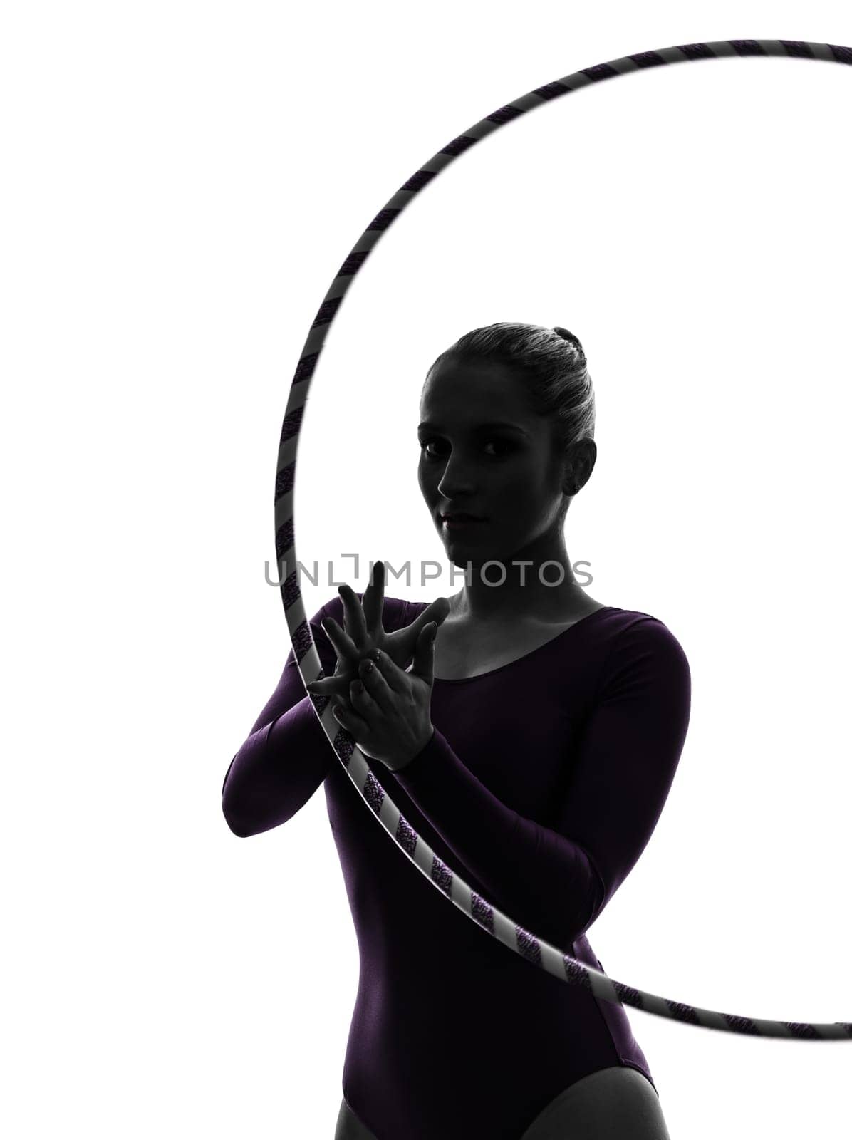 one caucasian woman exercising Rhythmic Gymnastics hula hoop  in silhouette studio isolated on white background