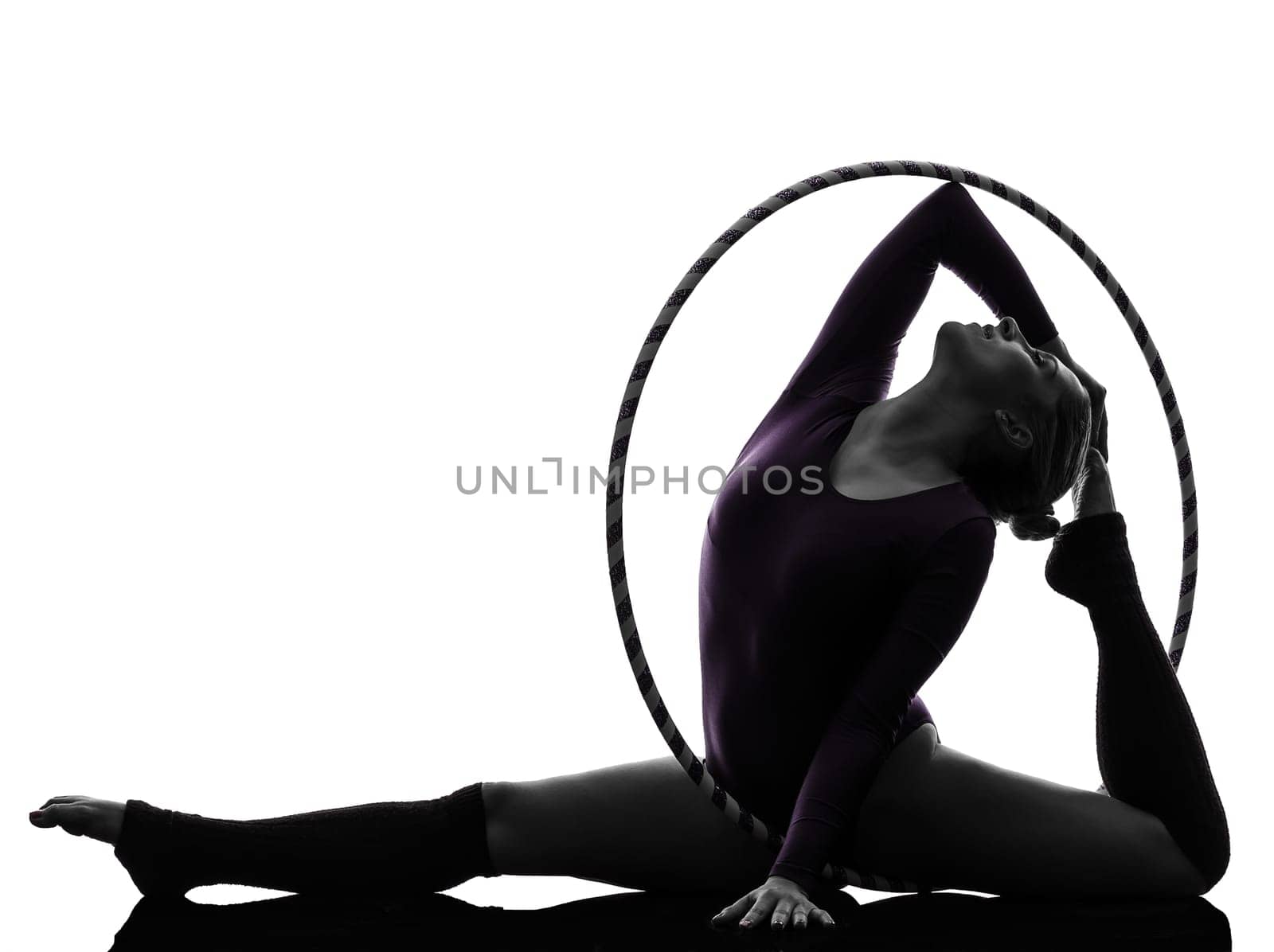 one caucasian woman exercising Rhythmic Gymnastics hula hoop  in silhouette studio isolated on white background