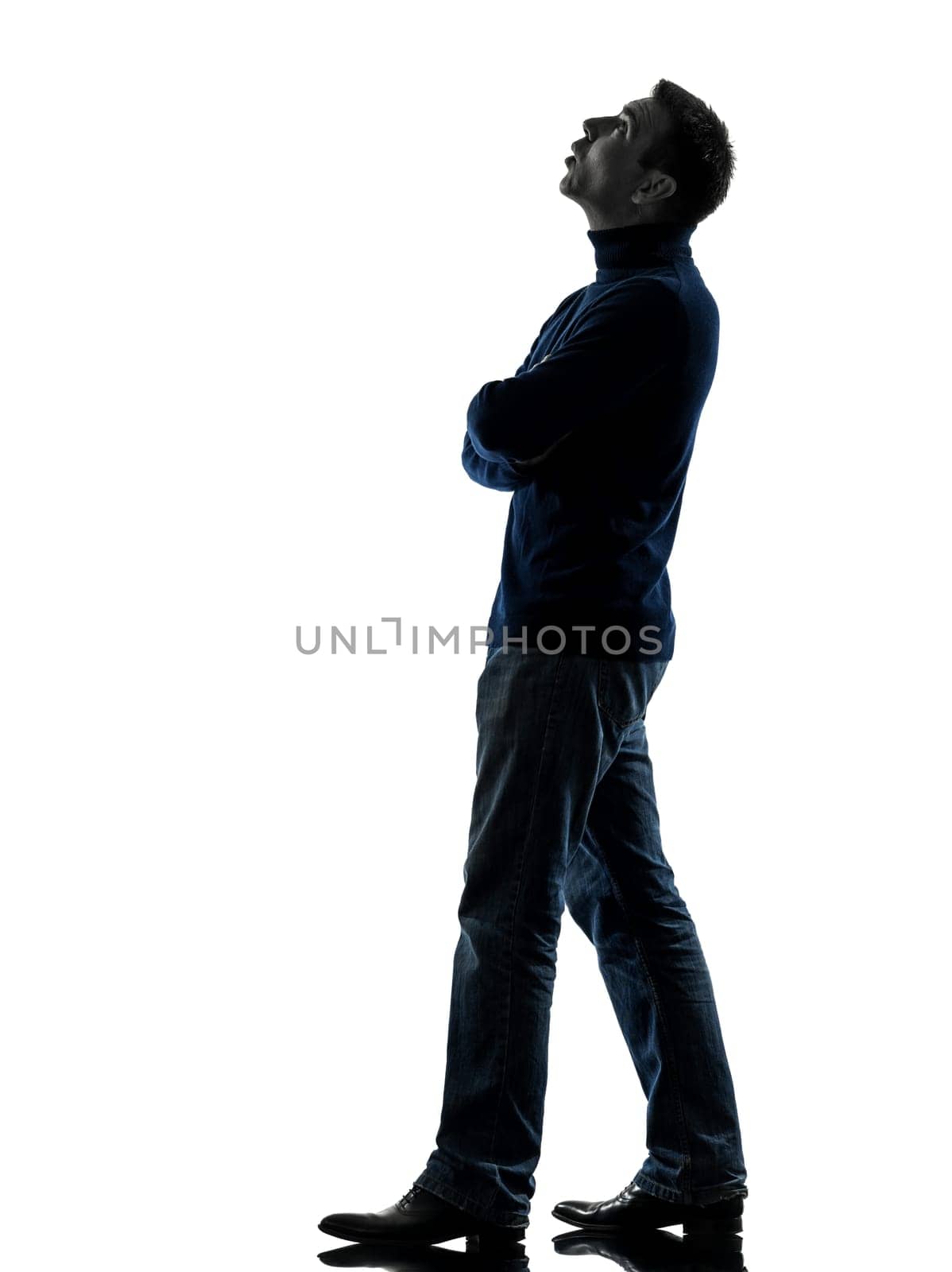 one caucasian man looking up pensive  full length in silhouette studio isolated on white background