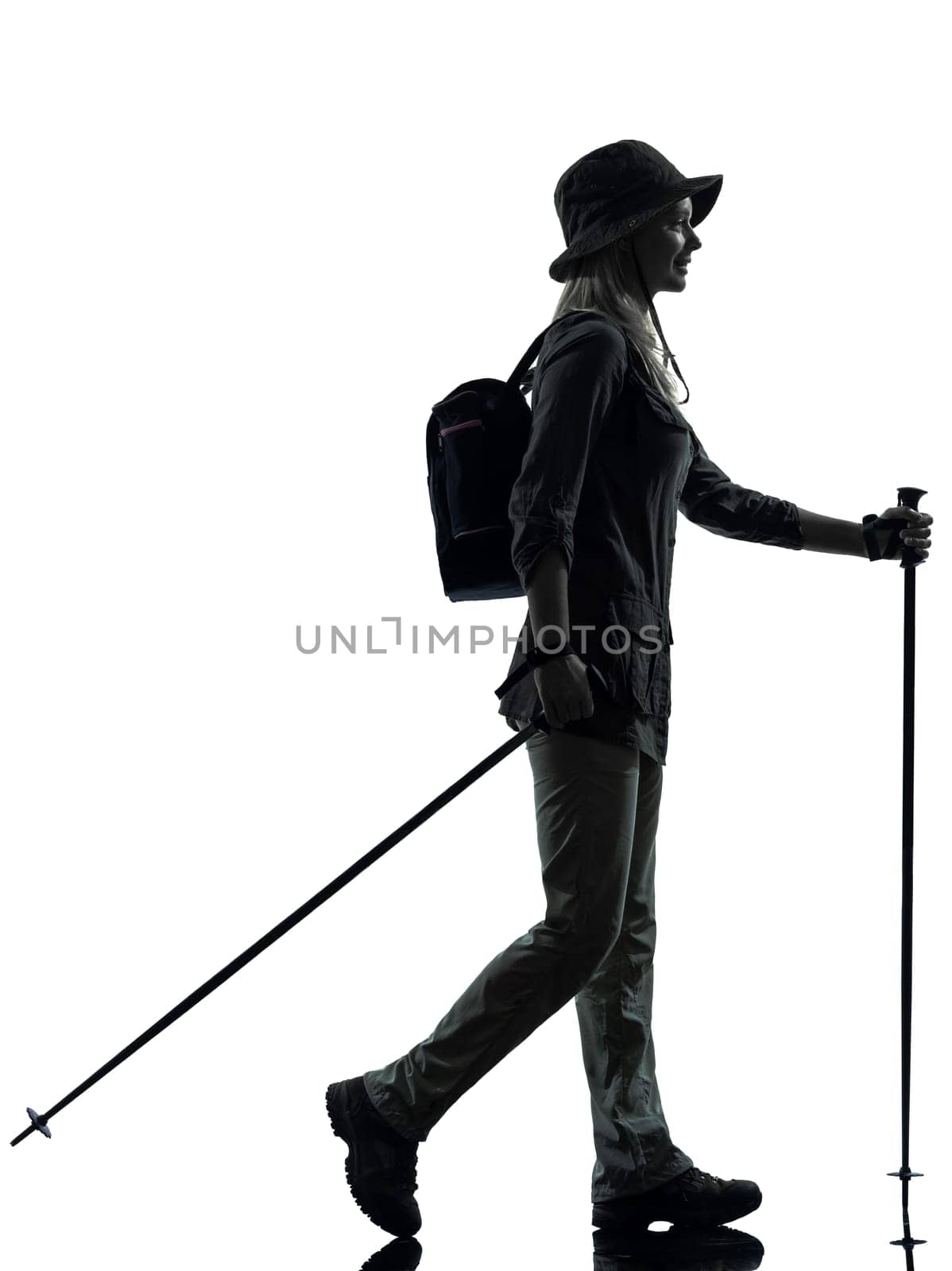 one caucasian woman trekker trekking walking in silhouette studio isolated on white background