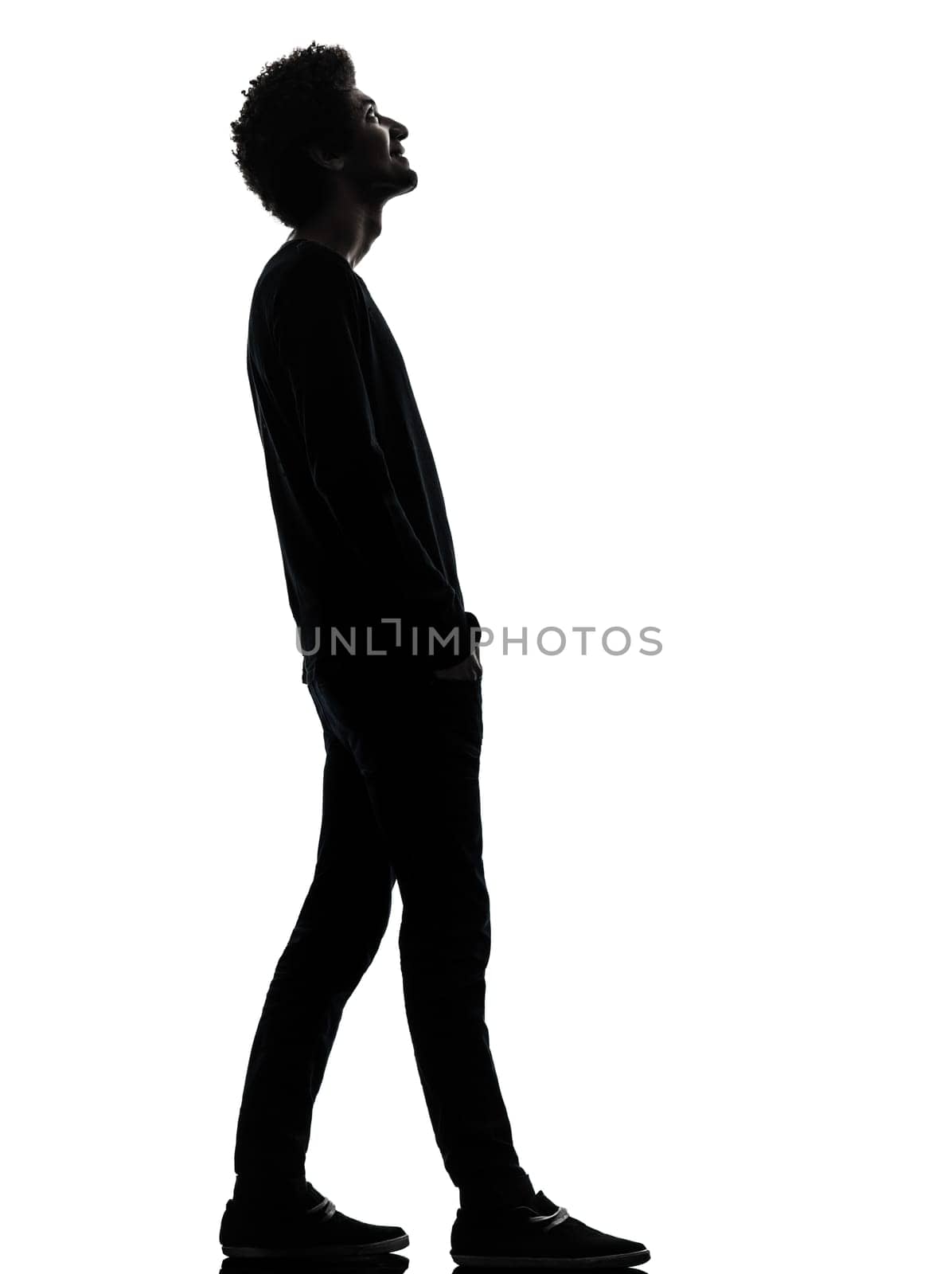 one african handsome young man standing  looking up smiling  in silhouette studio isolated on white background