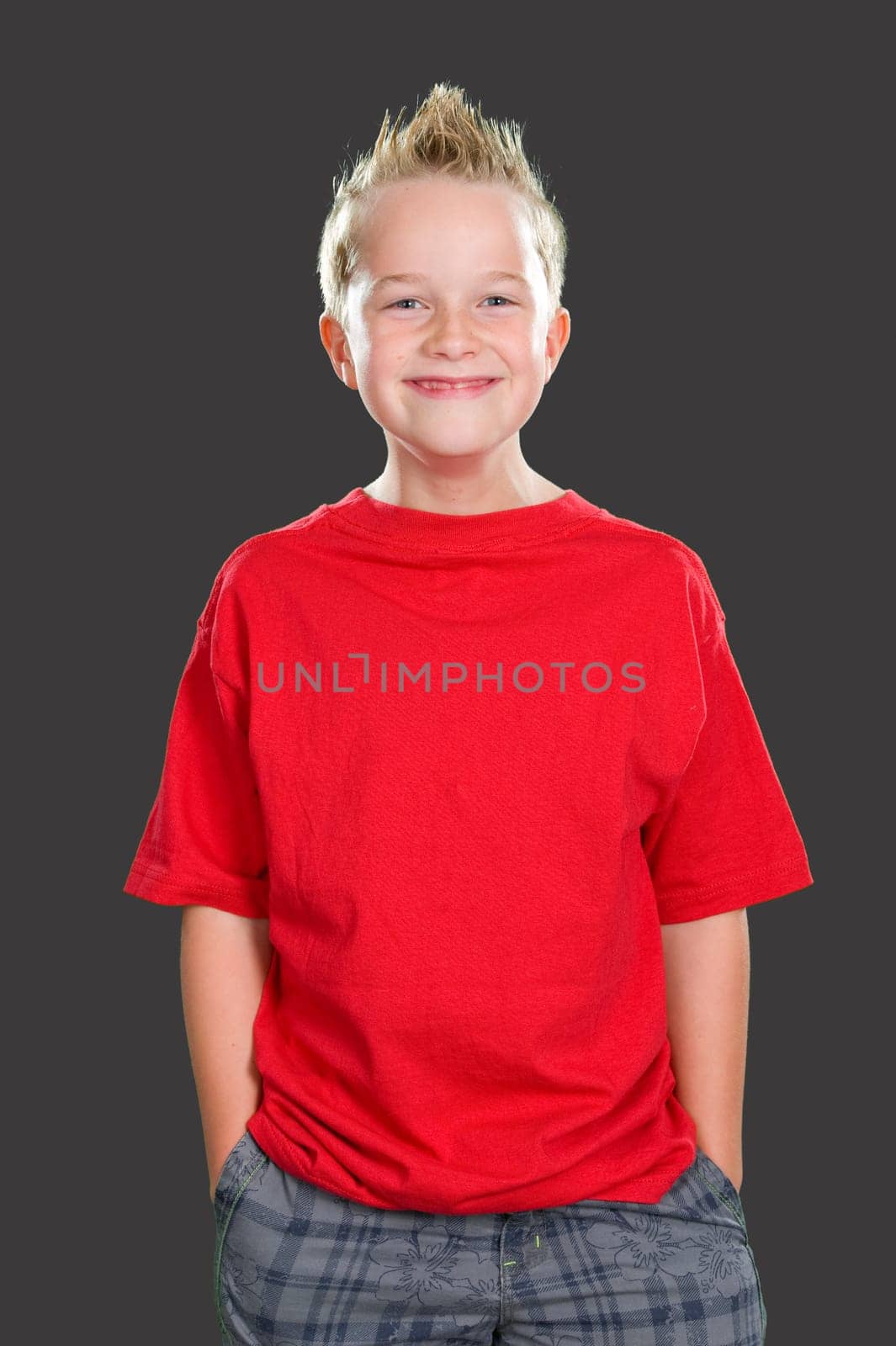 happy boy in front of gray background