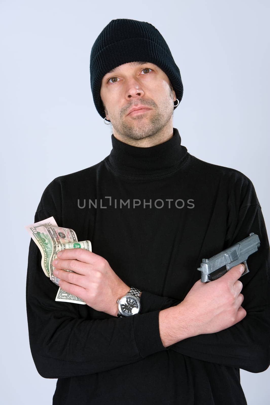 man in black outfit with money and gun
