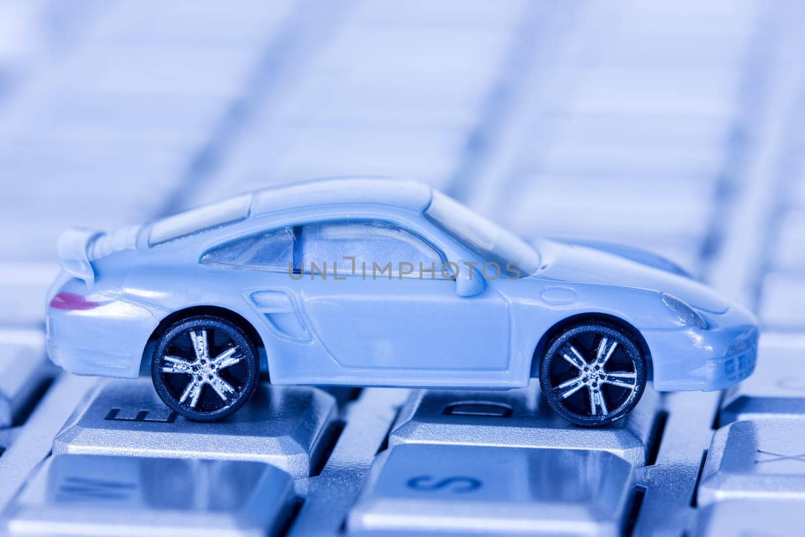 Picture of small car on the computer keyboard